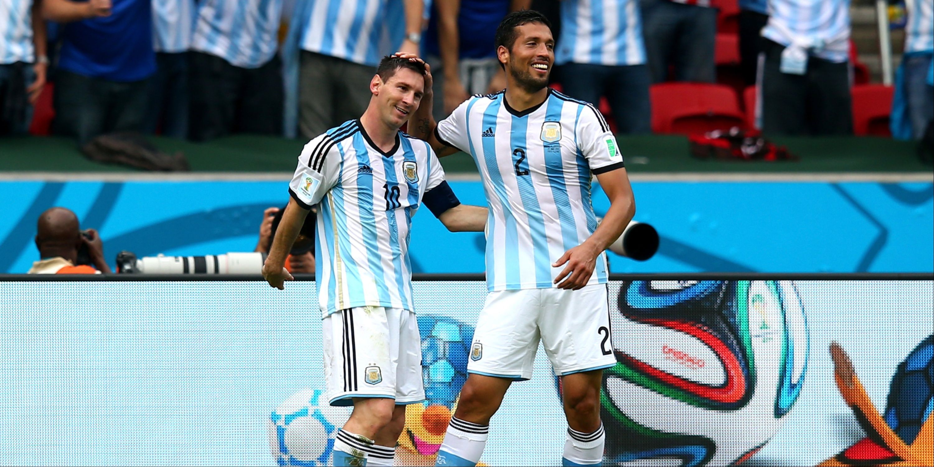 Lionel Messi (L) of Argentina celebrates with his teammate Ezequiel Garay