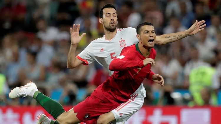 Portugal's Cristiano Ronaldo in action with Spain's Sergio Busquets