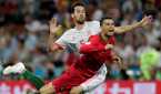 Portugal's Cristiano Ronaldo in action with Spain's Sergio Busquets