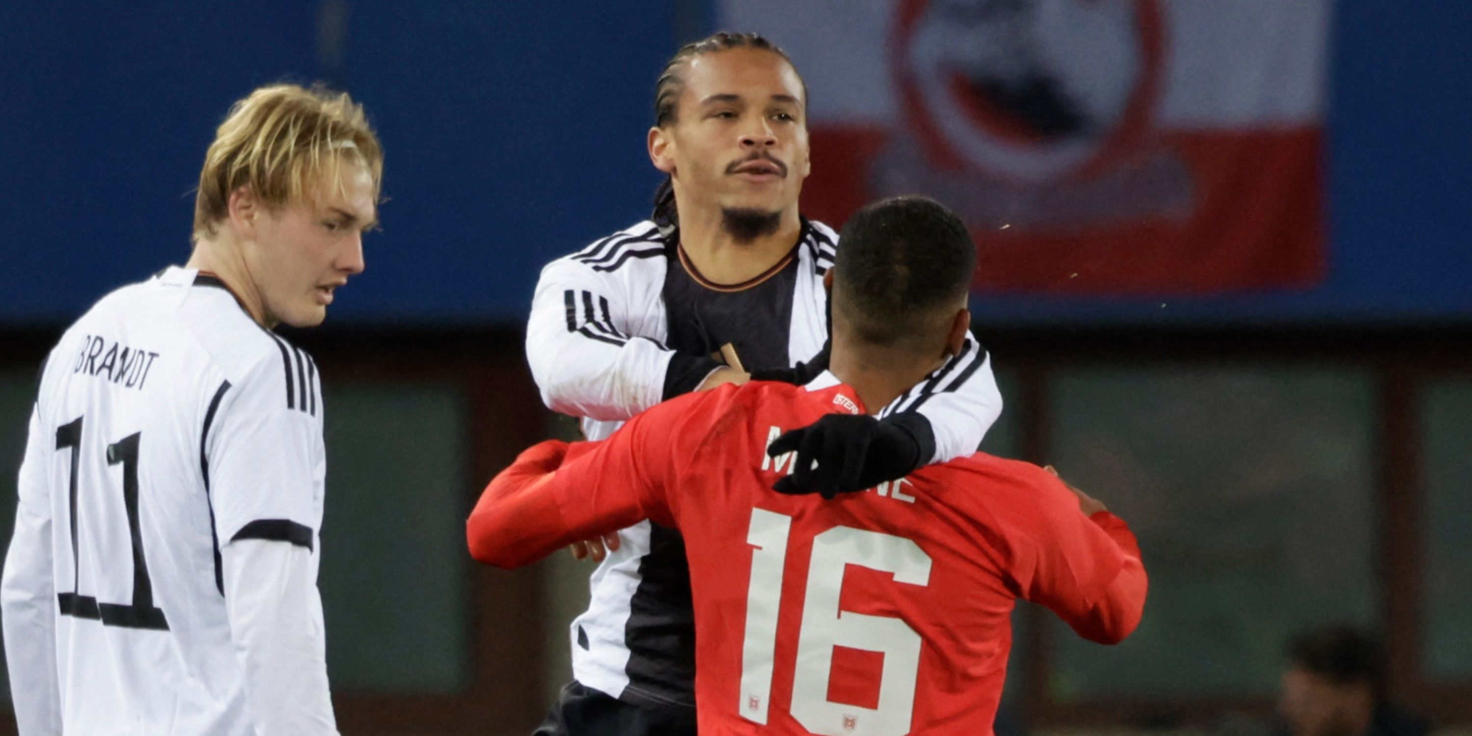 Germany's Leroy Sane clashes with Austria's Philip Mwene before he is shown a red card
