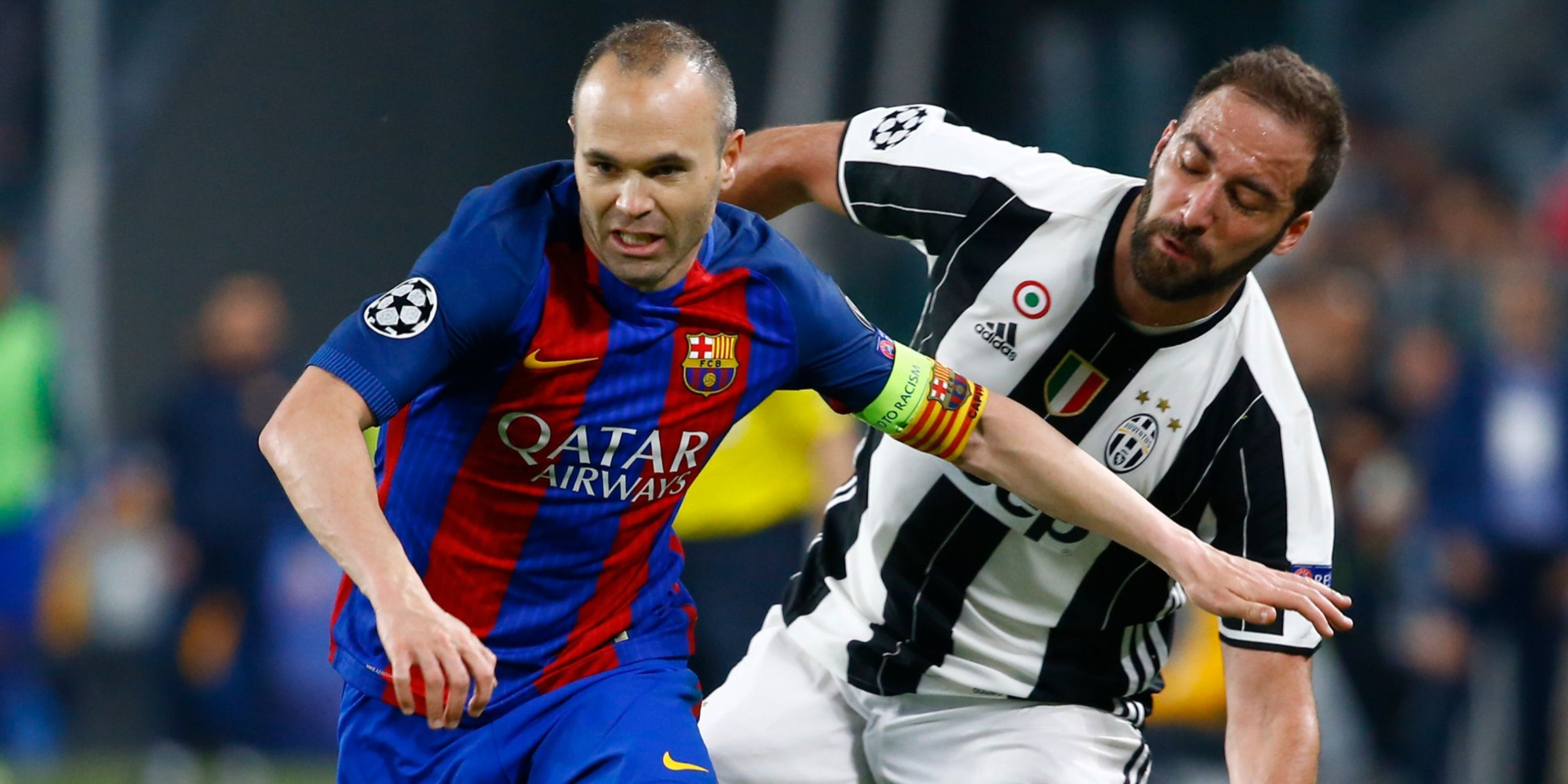 Barcelona's Andres Iniesta in action with Juventus' Gonzalo Higuain