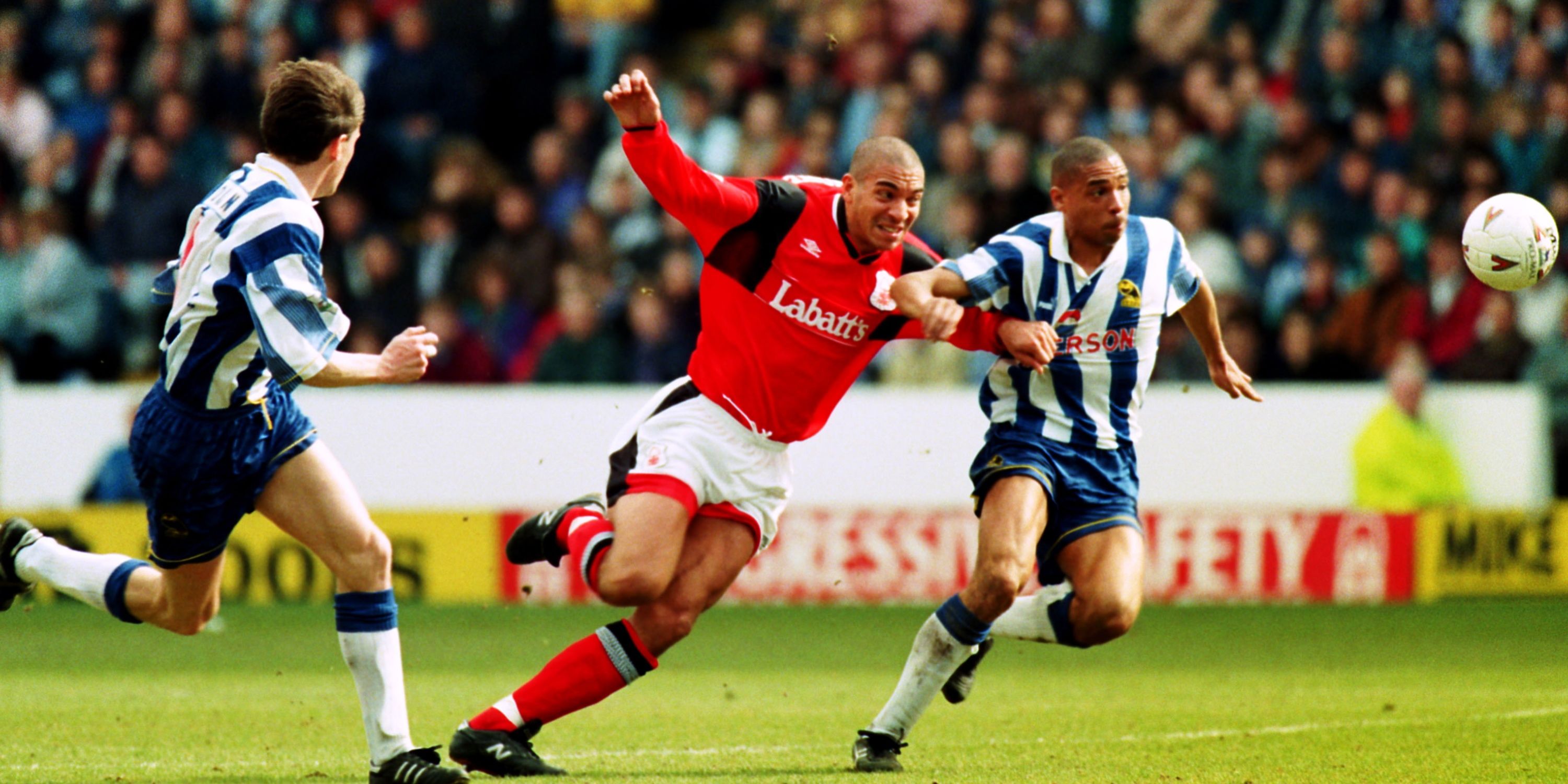 Nottingham Forest's Stan Collymore competes the ball with Sheffield Wednesday's Des Walker.