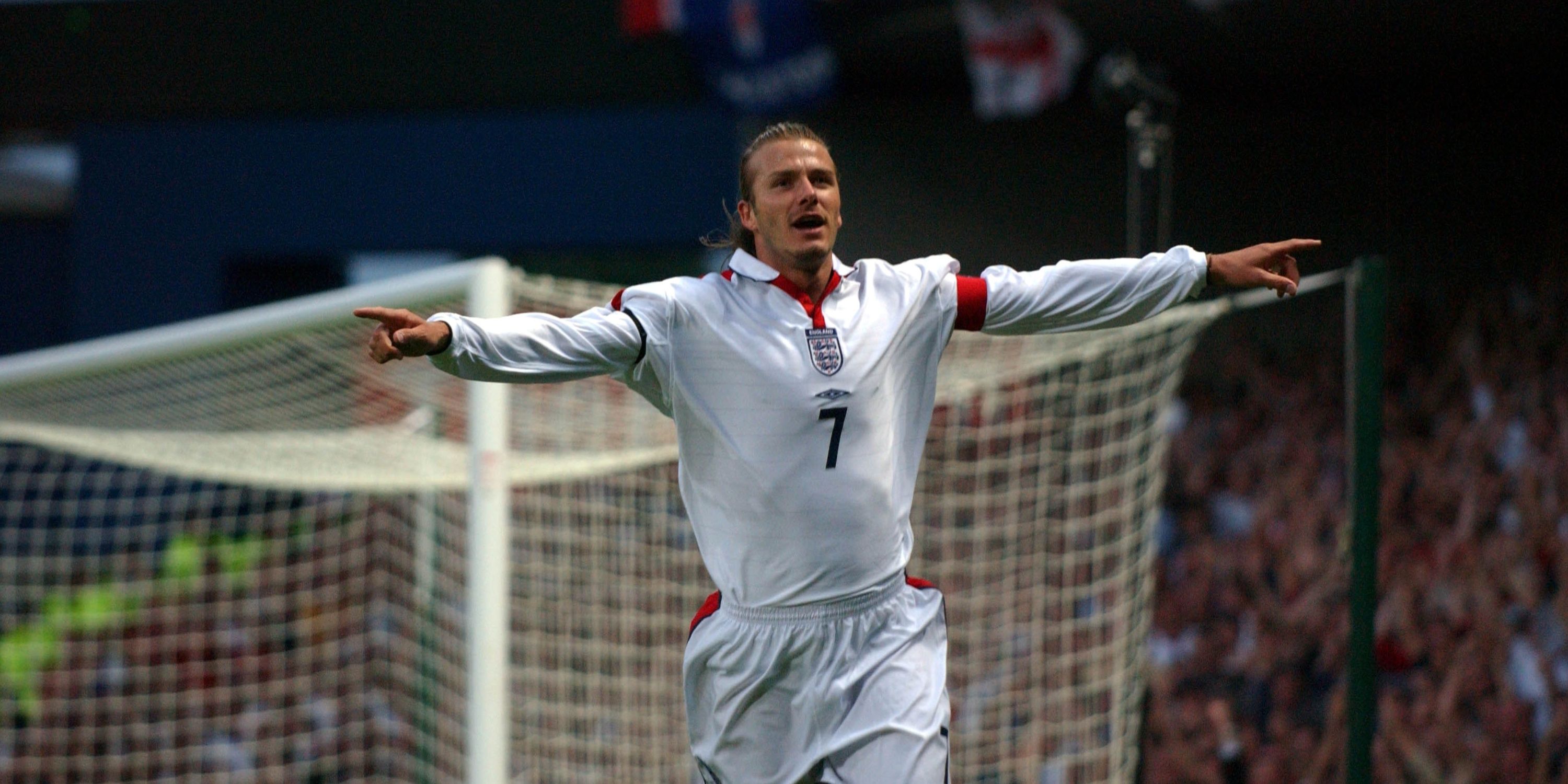 David Beckham celebrates scoring for England. 
