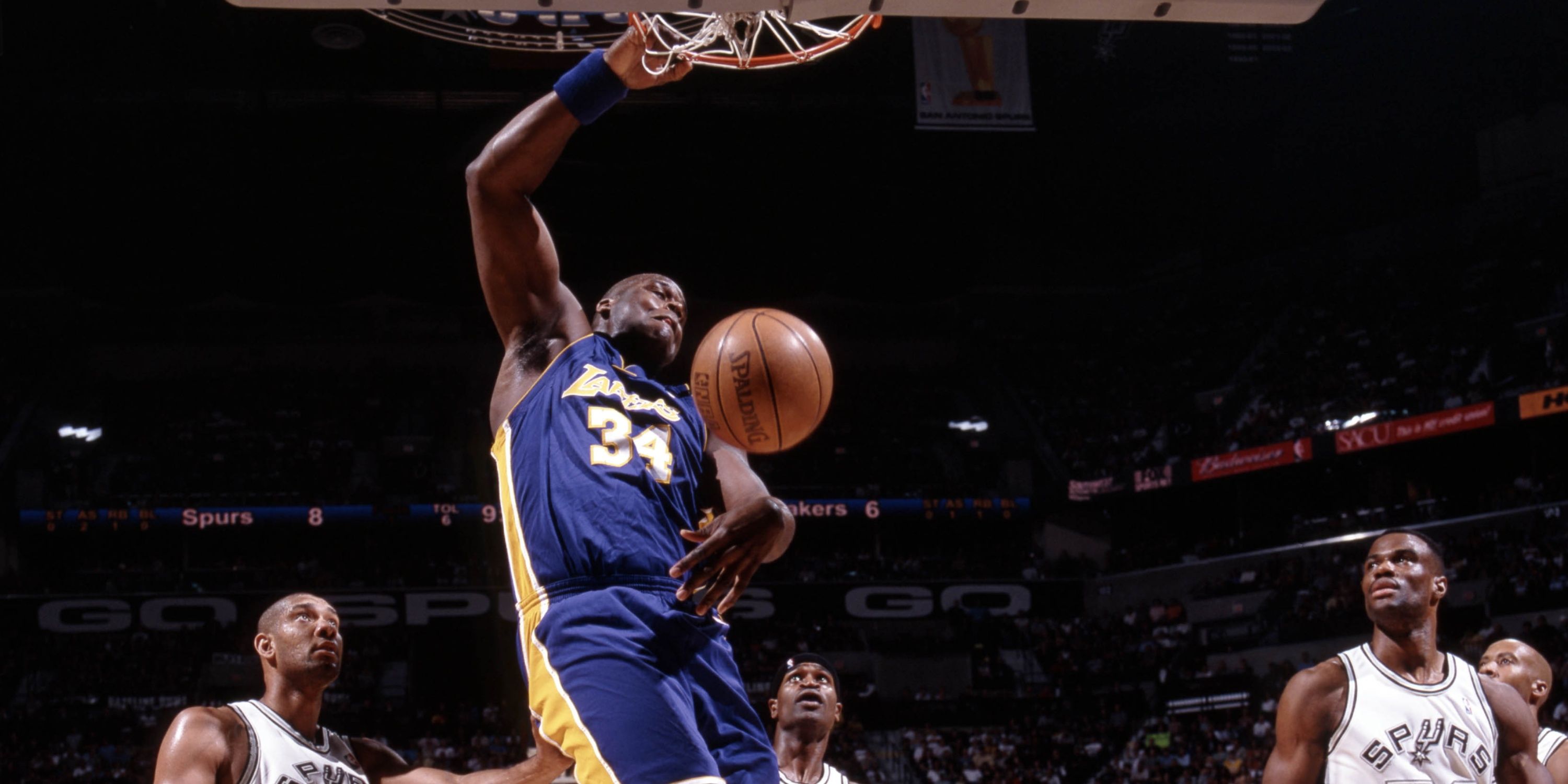 Shaquille O'Neal dunks against the Spurs