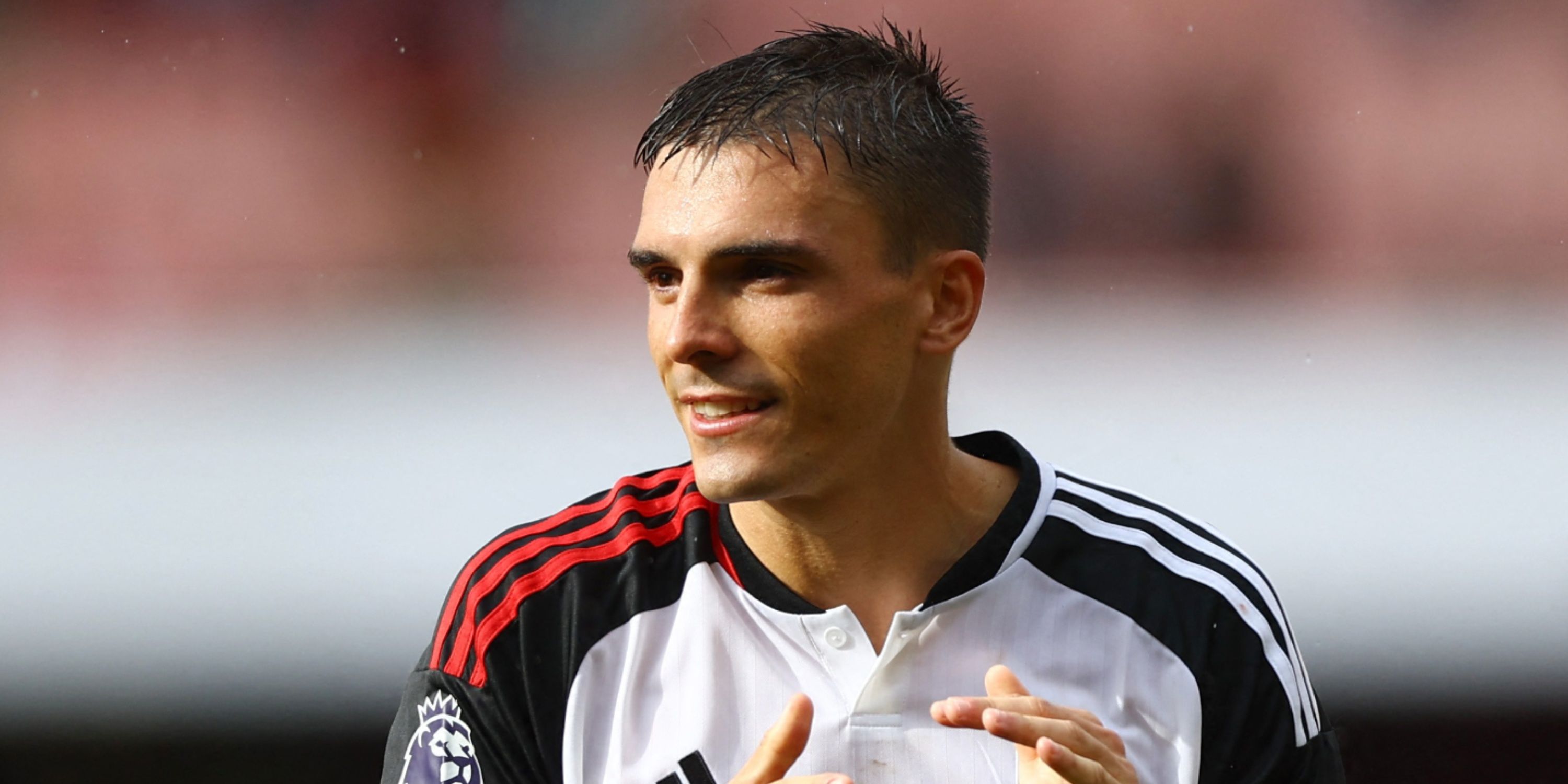 Fulham defensive midfielder Joao Palhinha smiling on the pitch