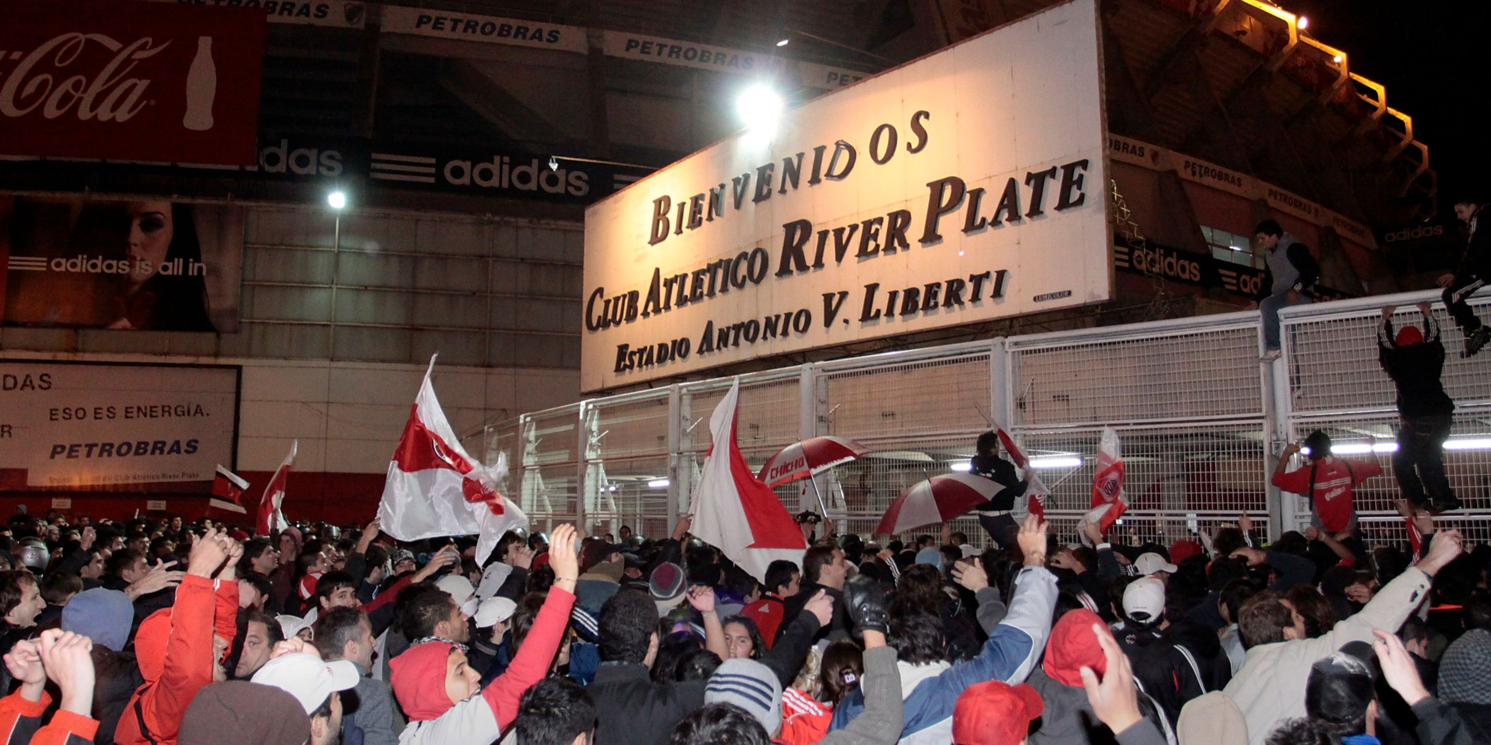 Fans of Argentine River Plate soccer club try to storm into El Monumental stadium after relegation
