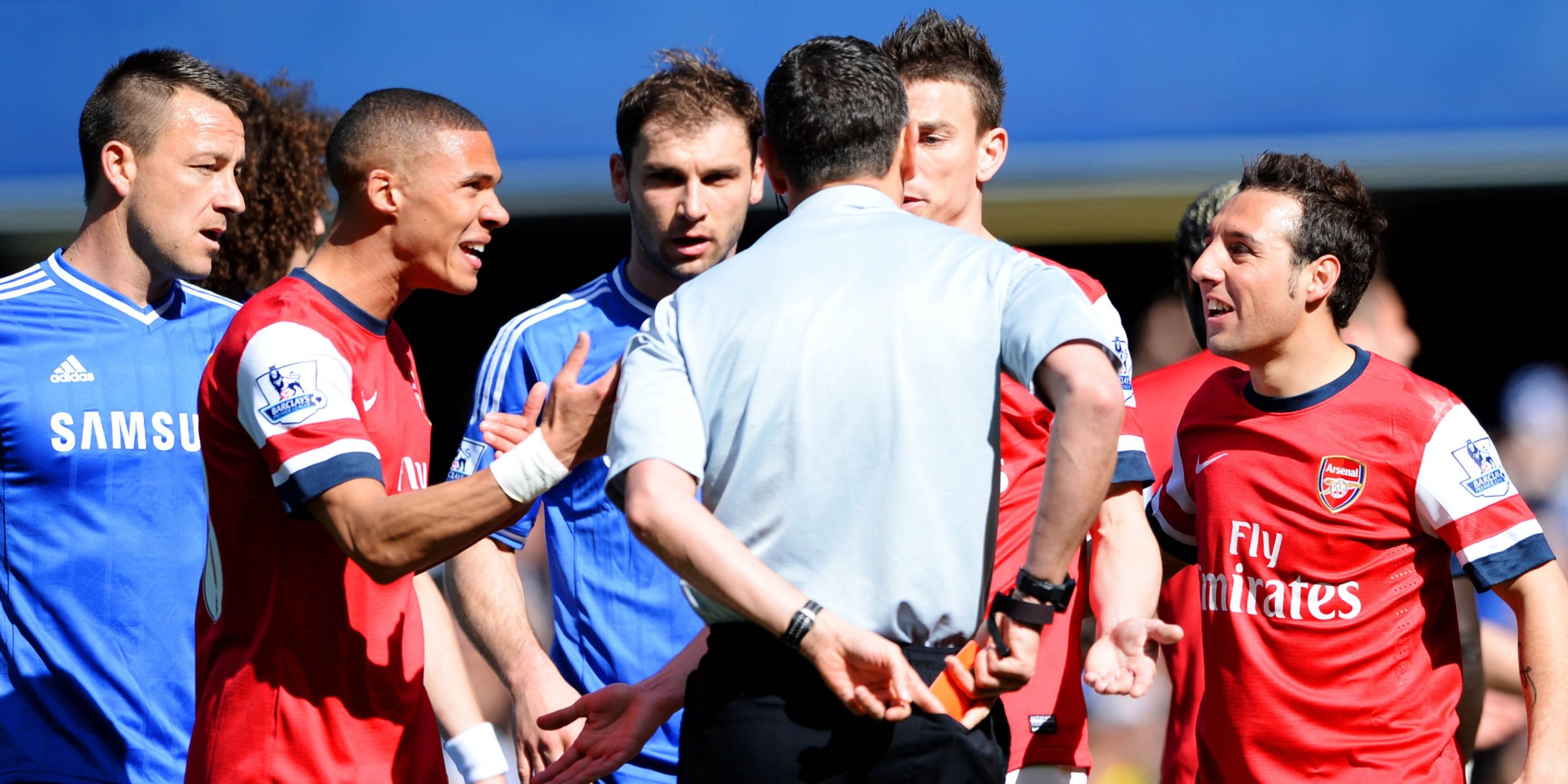 Andre Marriner shows a red card to Arsenal's Kieran Gibbs after Alex Oxlade Chamberlain (not pictured) conceded a penalty 
