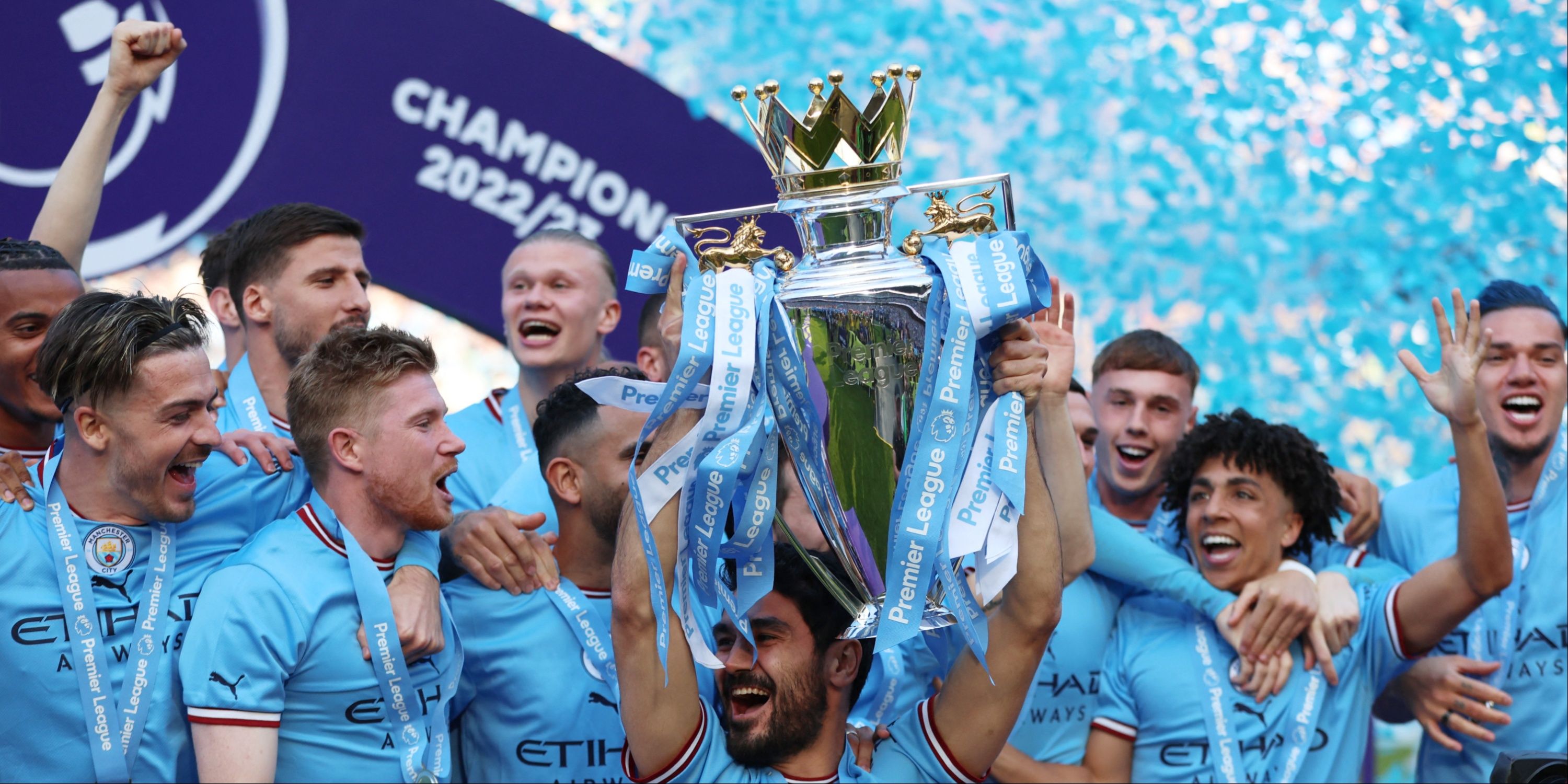 Manchester City players lift the Premier League trophy. 