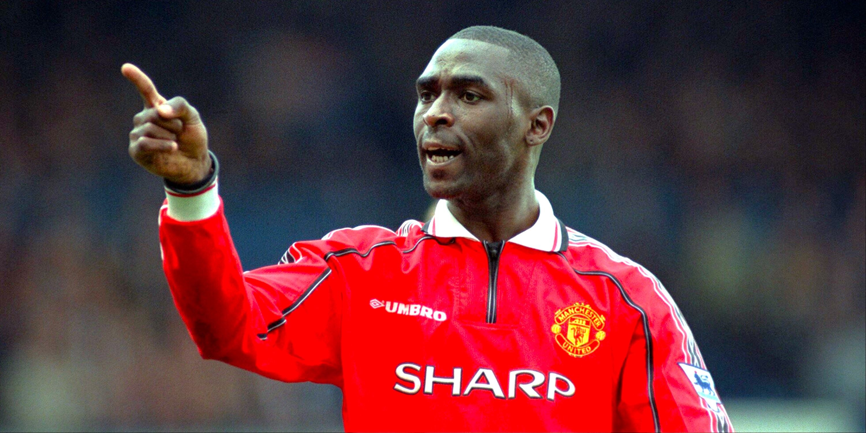 Andy Cole celebrates scoring for Manchester United.