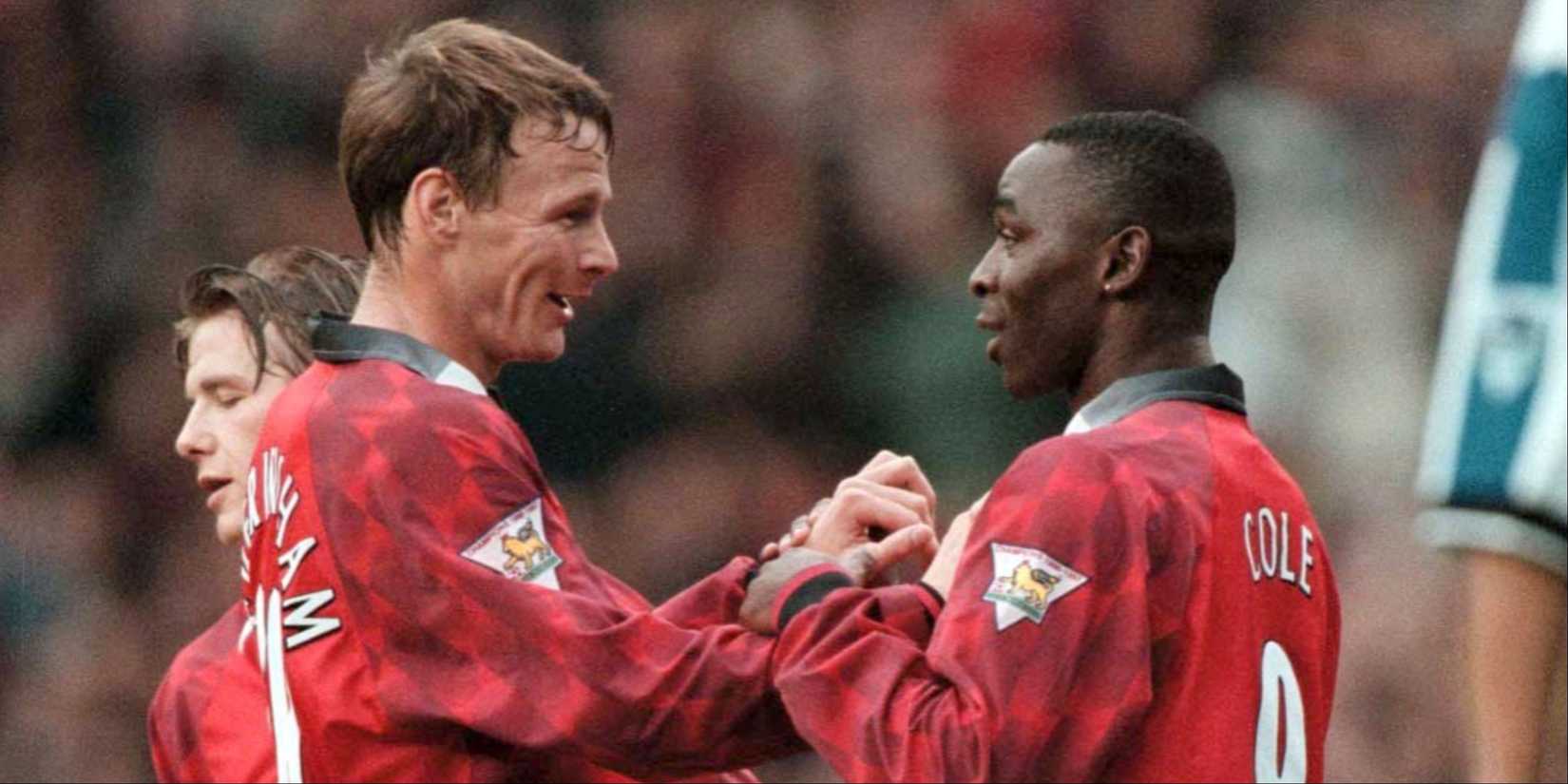 Manchester United teammates Andy Cole and Teddy Sheringham celebrate a goal together. 