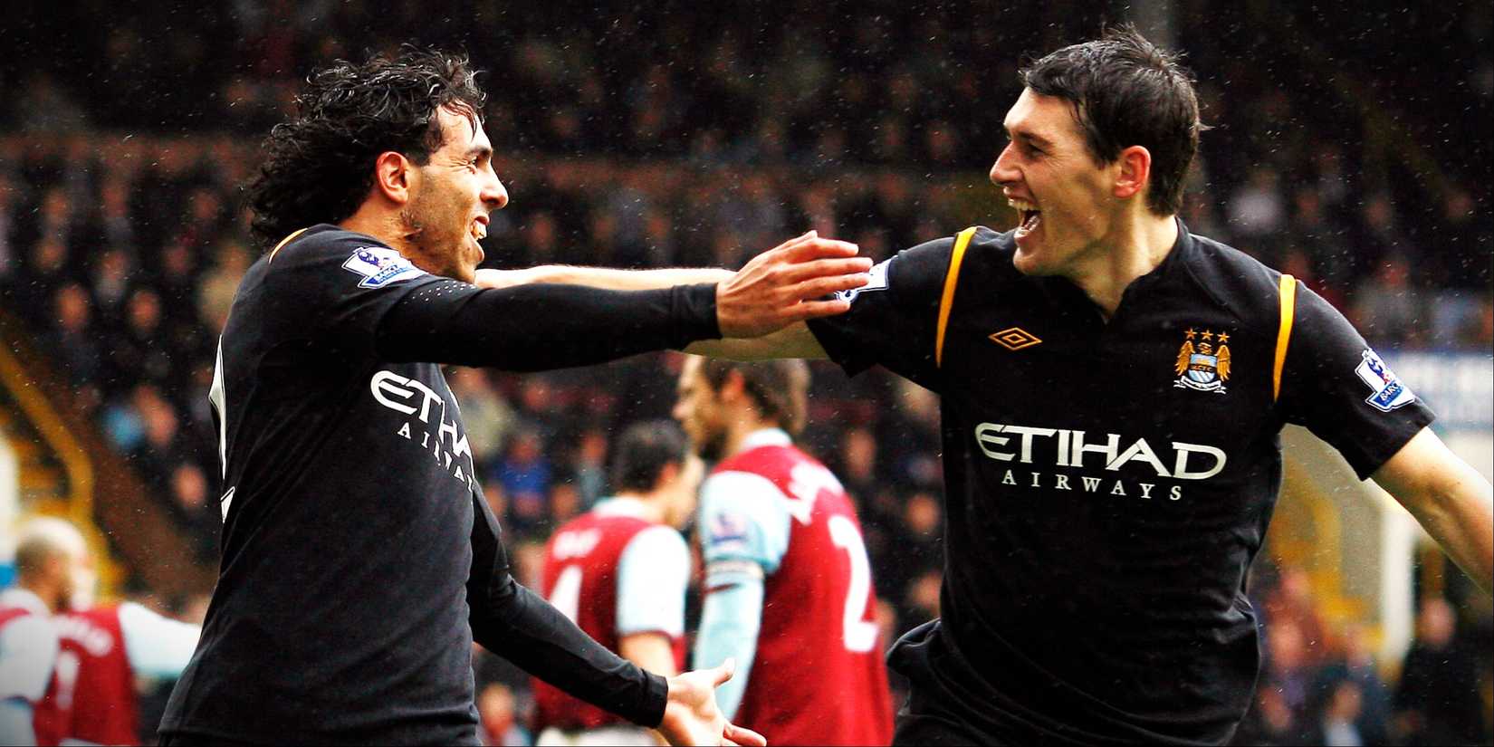 Manchester City pair Carlos Tevez and Gareth Barry celebrate scoring against Burnley.