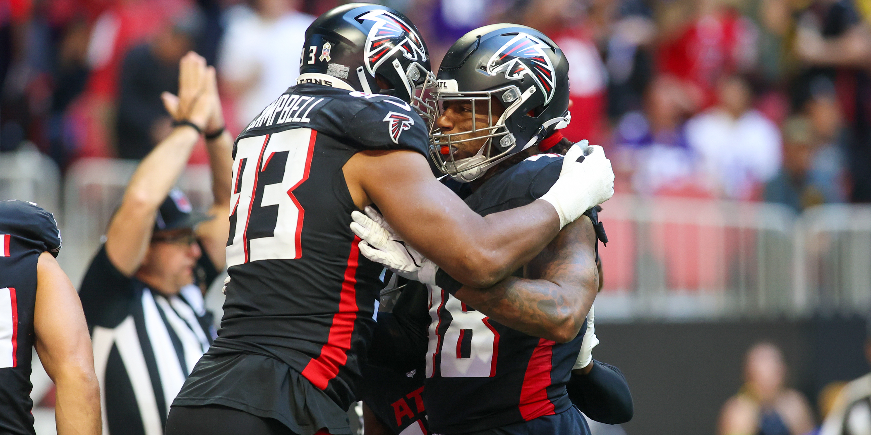 Atlanta Falcons defensive tackle Calais Campbell reacts with linebacker Bud Dupree