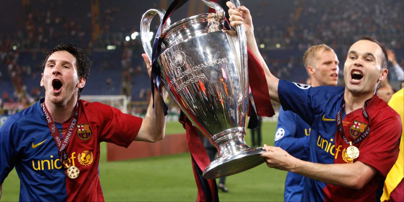 Lionel Messi and Andres Iniesta lifting the Champions League