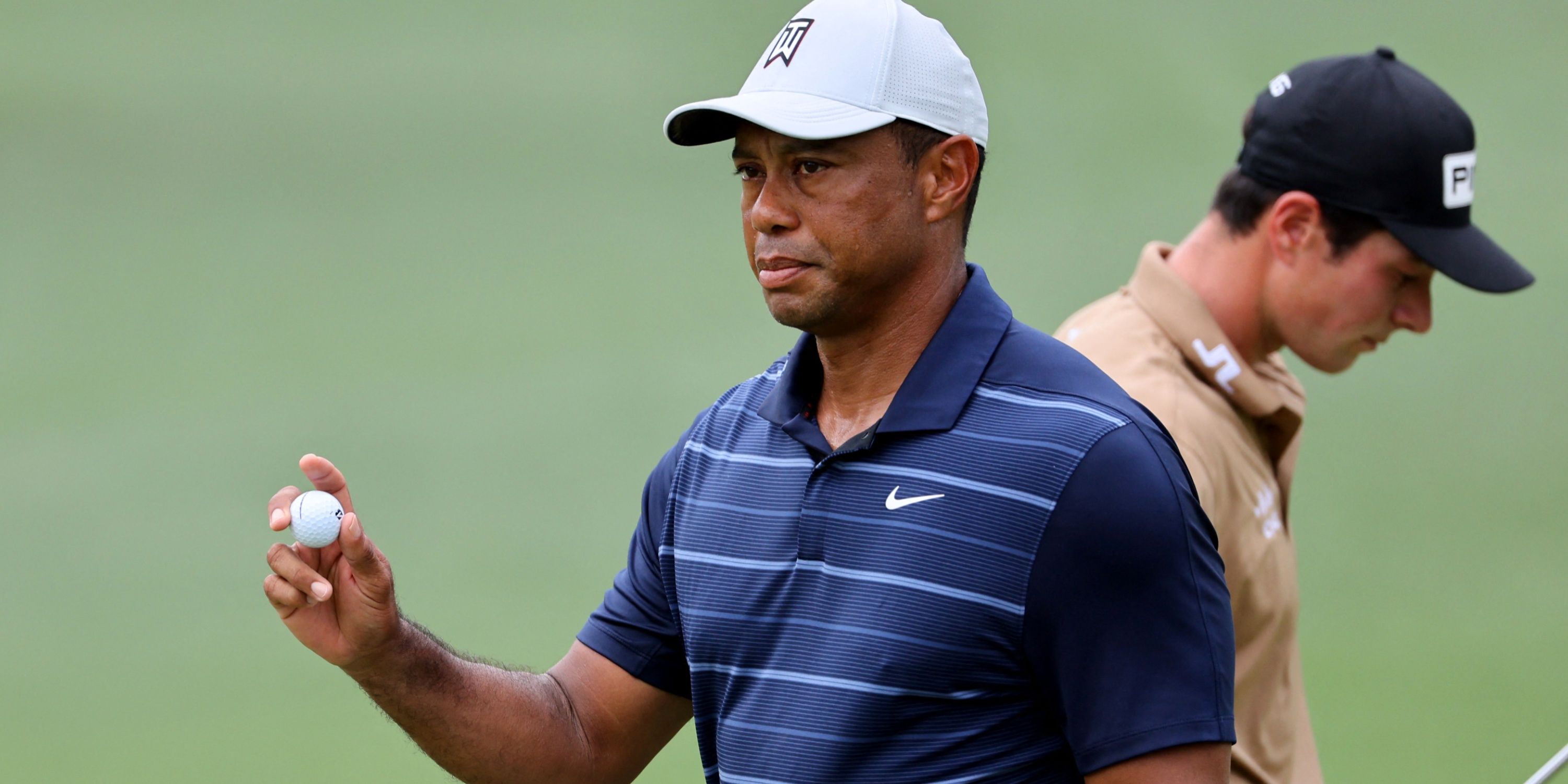 Tiger Woods with a golf ball in hand