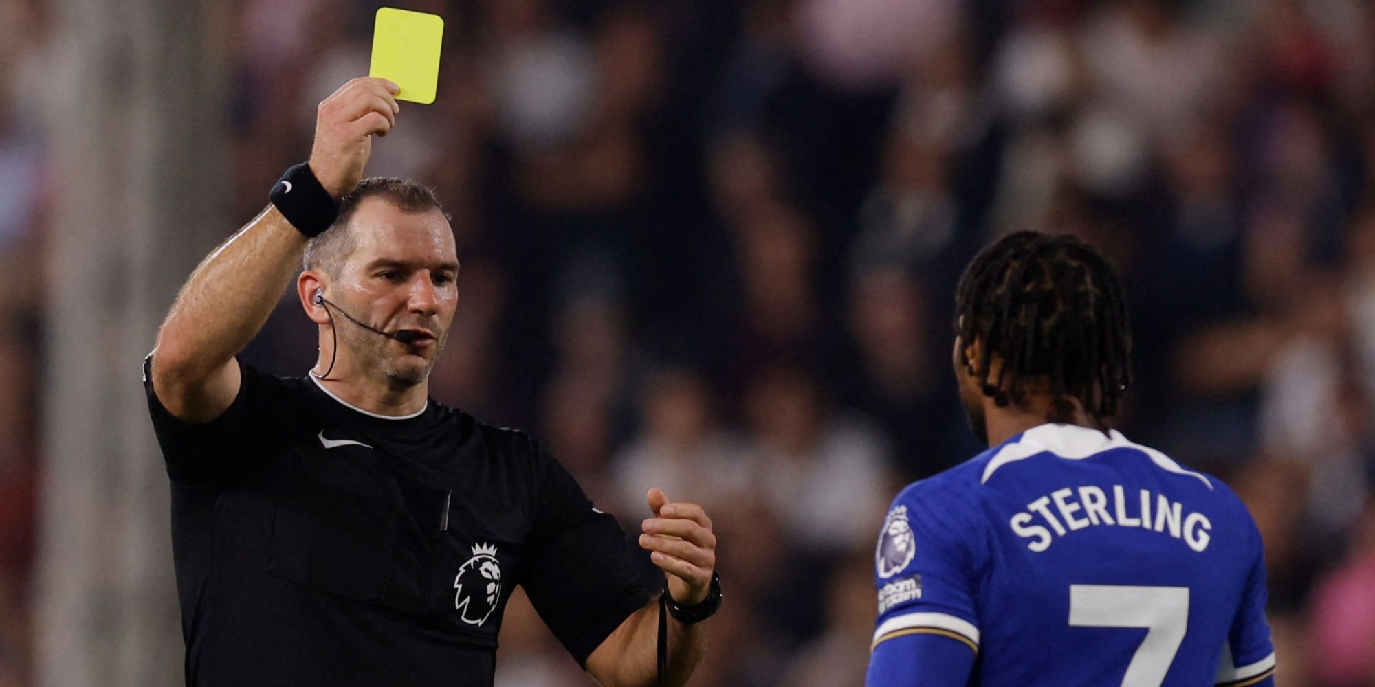 Chelsea's Raheem Sterling is shown a yellow card