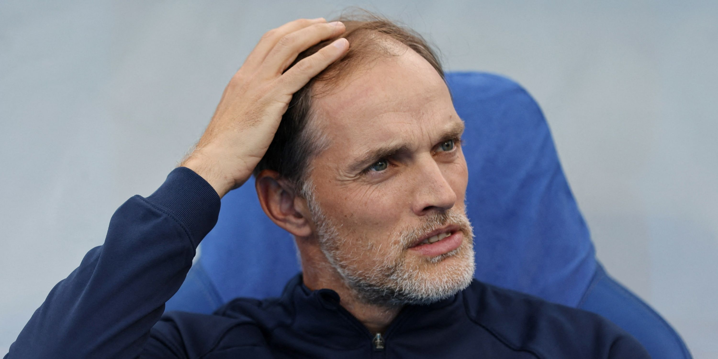 Thomas Tuchel sits in the dugout during his time at Chelsea.