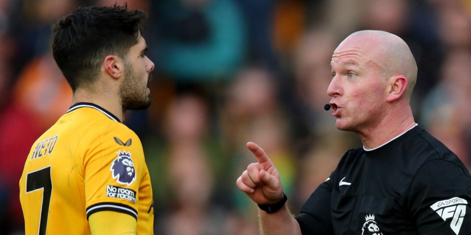 Referee Simon Hooper speak to Wolverhampton Wanderers' Pedro Neto.