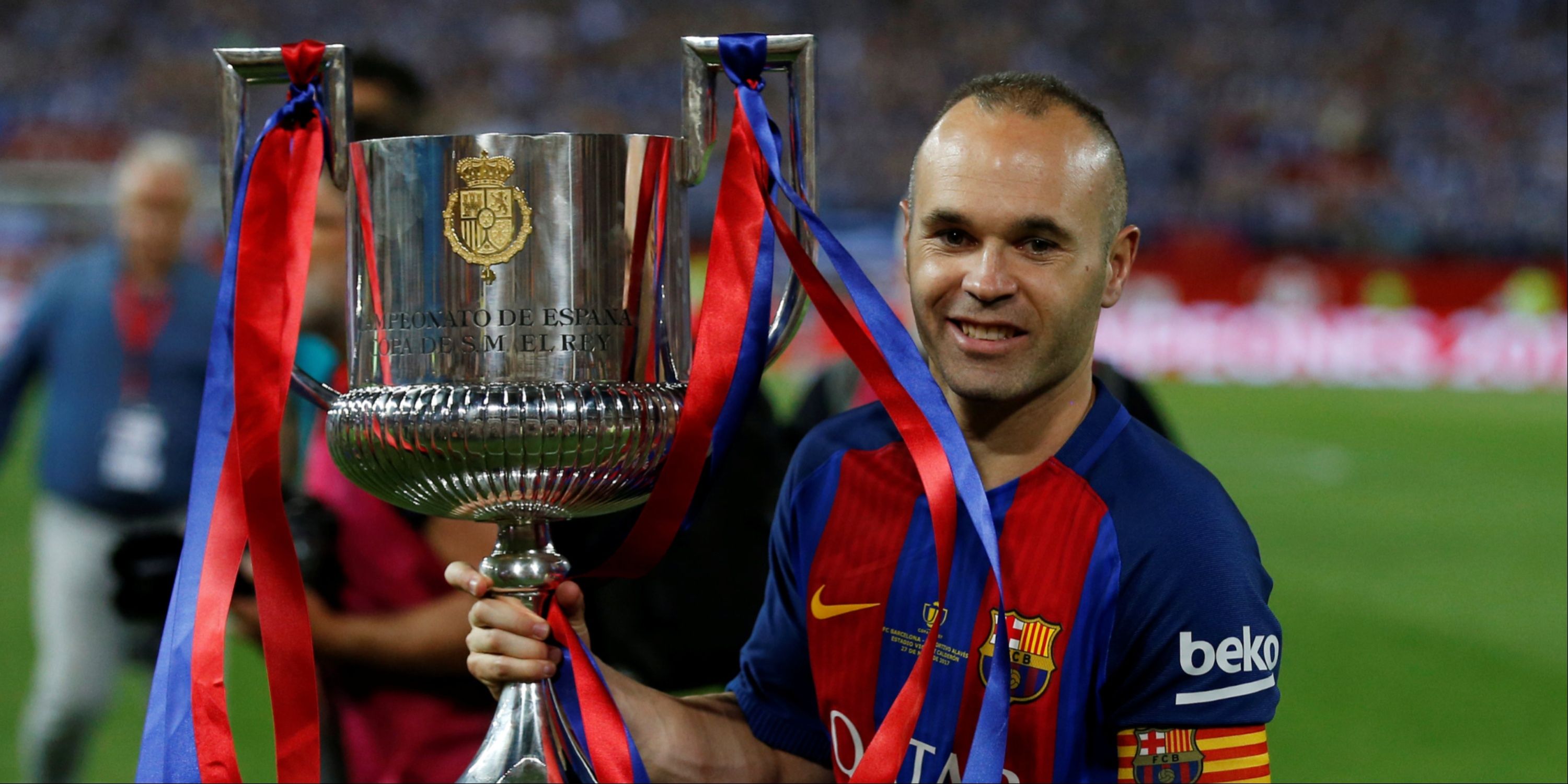 Andres Iniesta celebrates winning a trophy for Barcelona