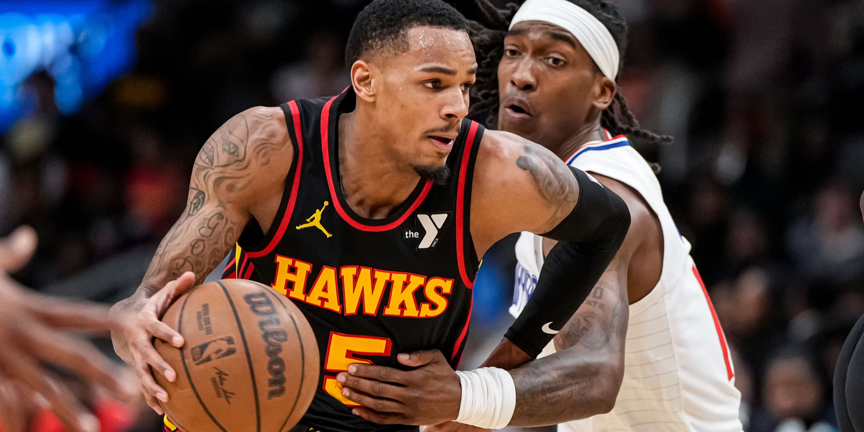 Hawks guard Dejounte Murray drives past his defender