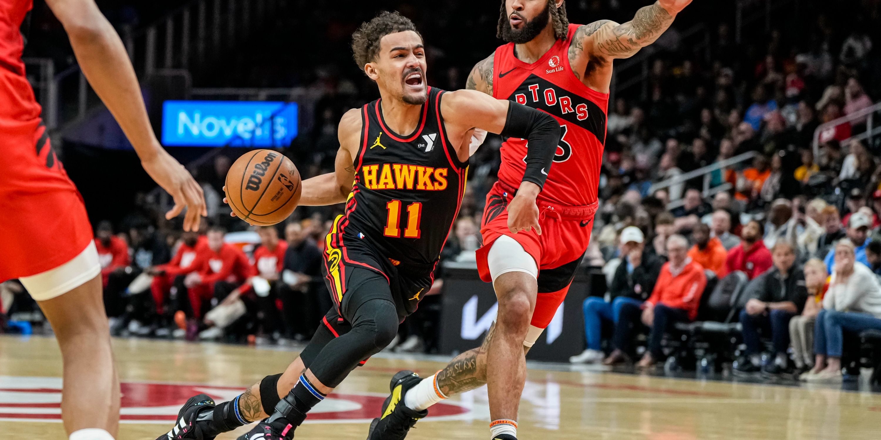 Hawks guard Trae Young drives past his defender