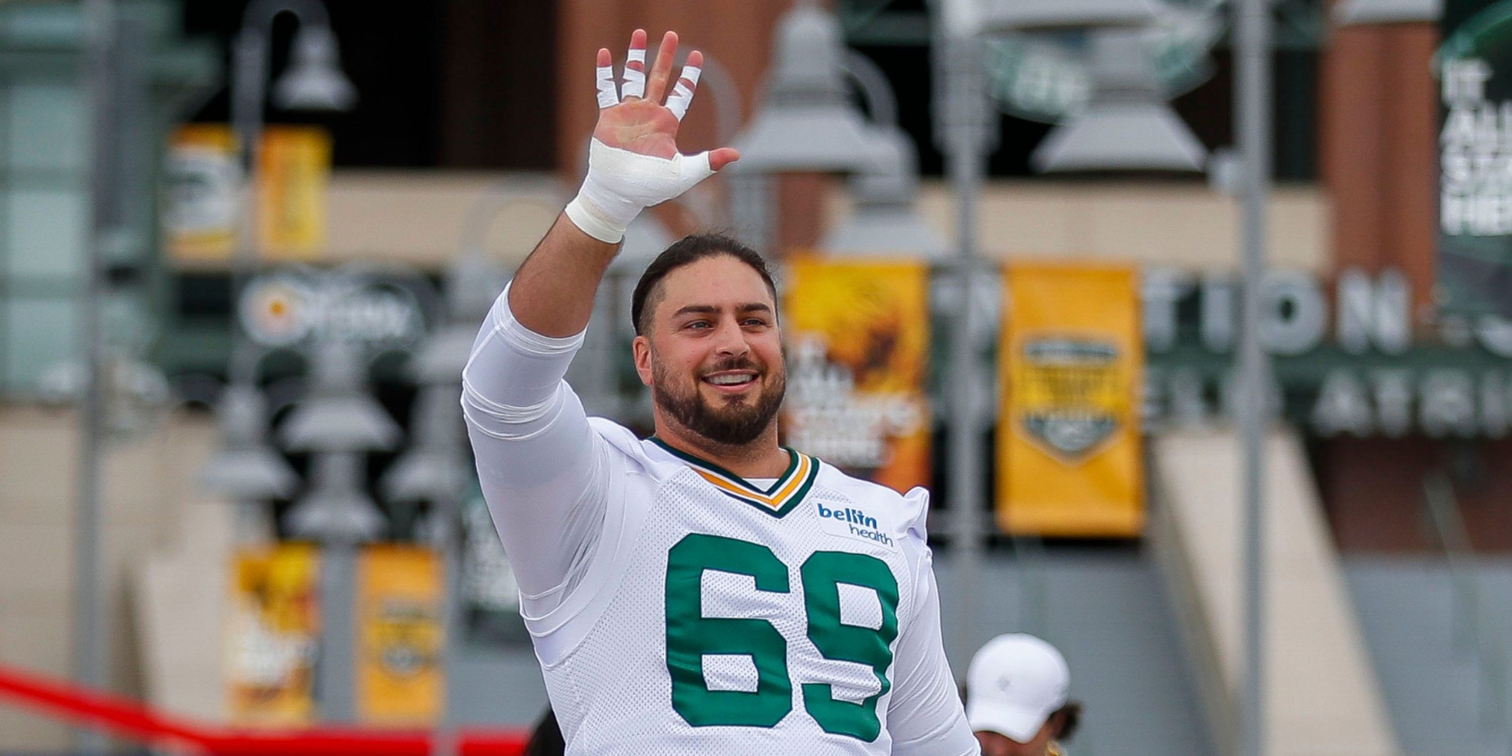 David Bakhtiari waves to fans at Packers' event