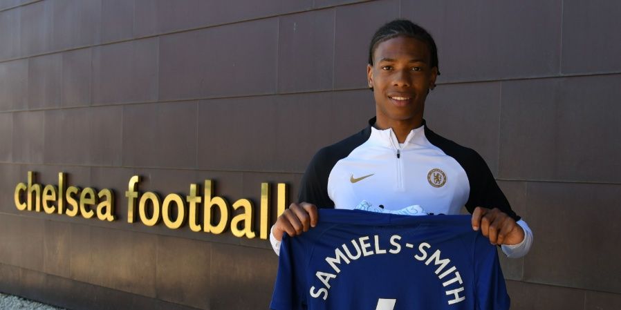 Ishe Samuels-Smith holding up a Chelsea shirt.