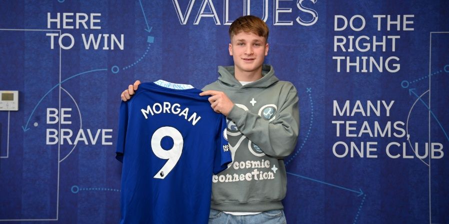 Jimmy-Jay Morgan holding up a Chelsea shirt.