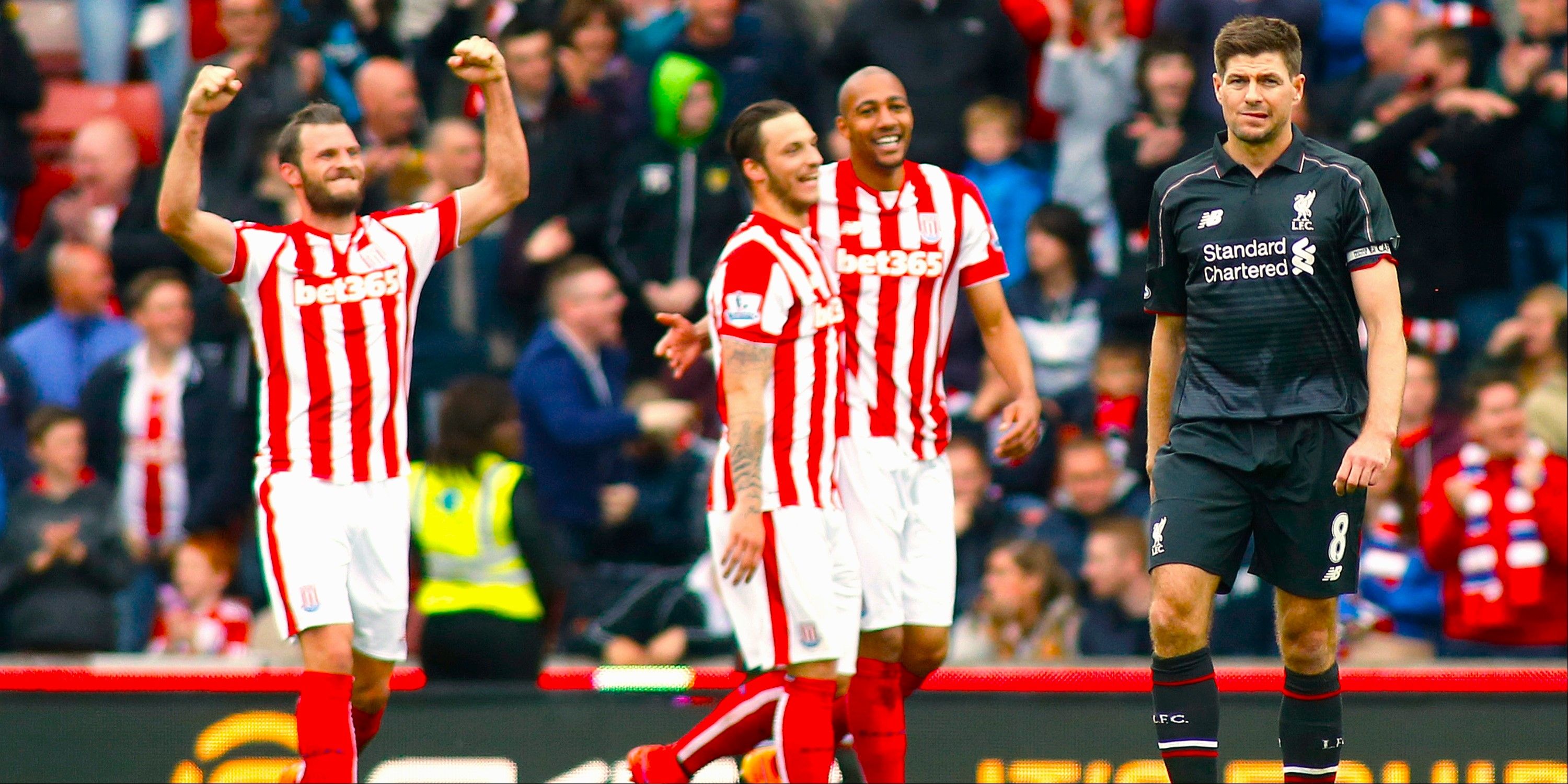 Stoke City players celebrate behind a dejected Steven Gerrard. 