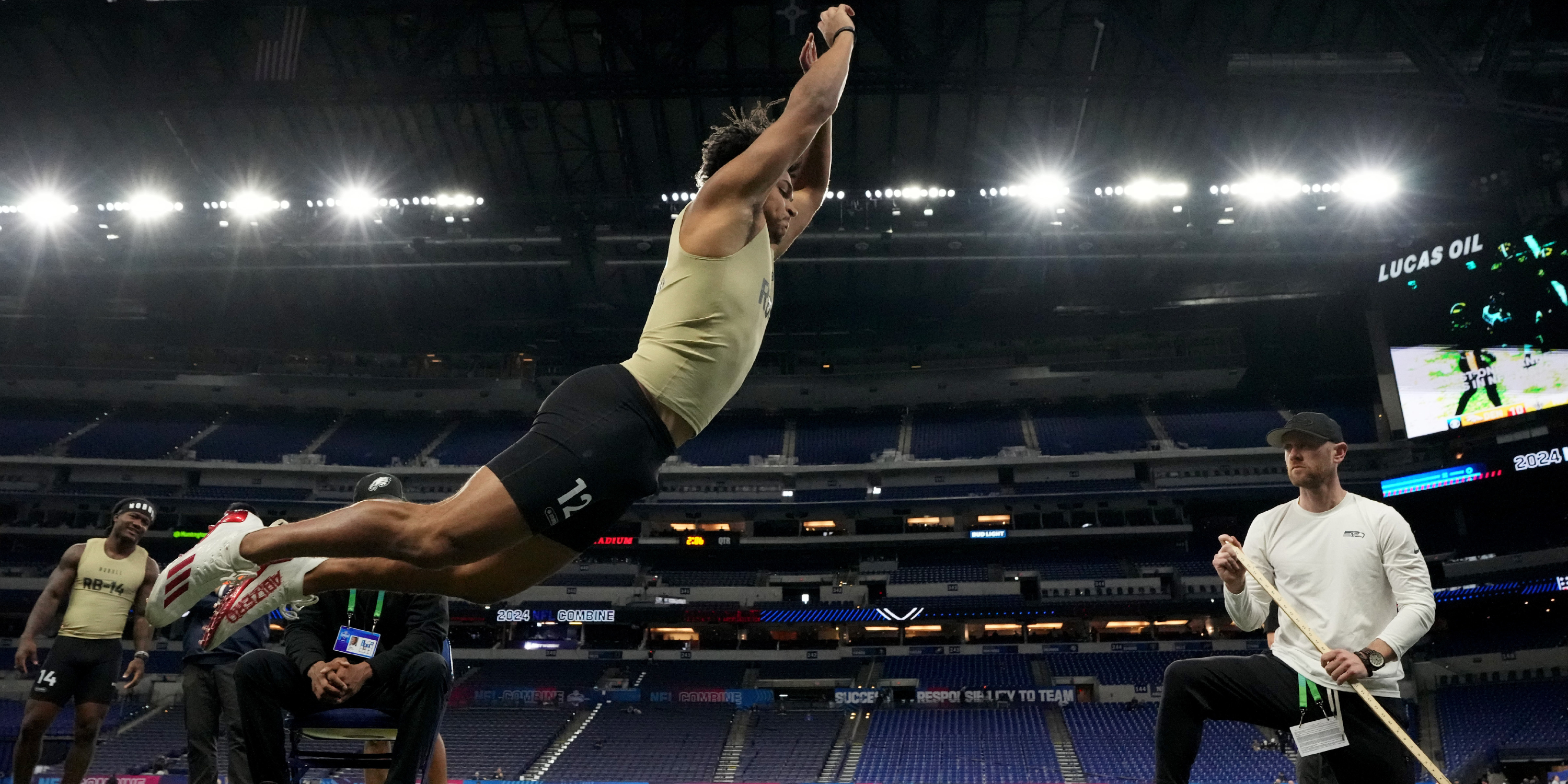 Louisville RB Isaac Guerendo performing broad jump at 2024 NFL Scouting Combine