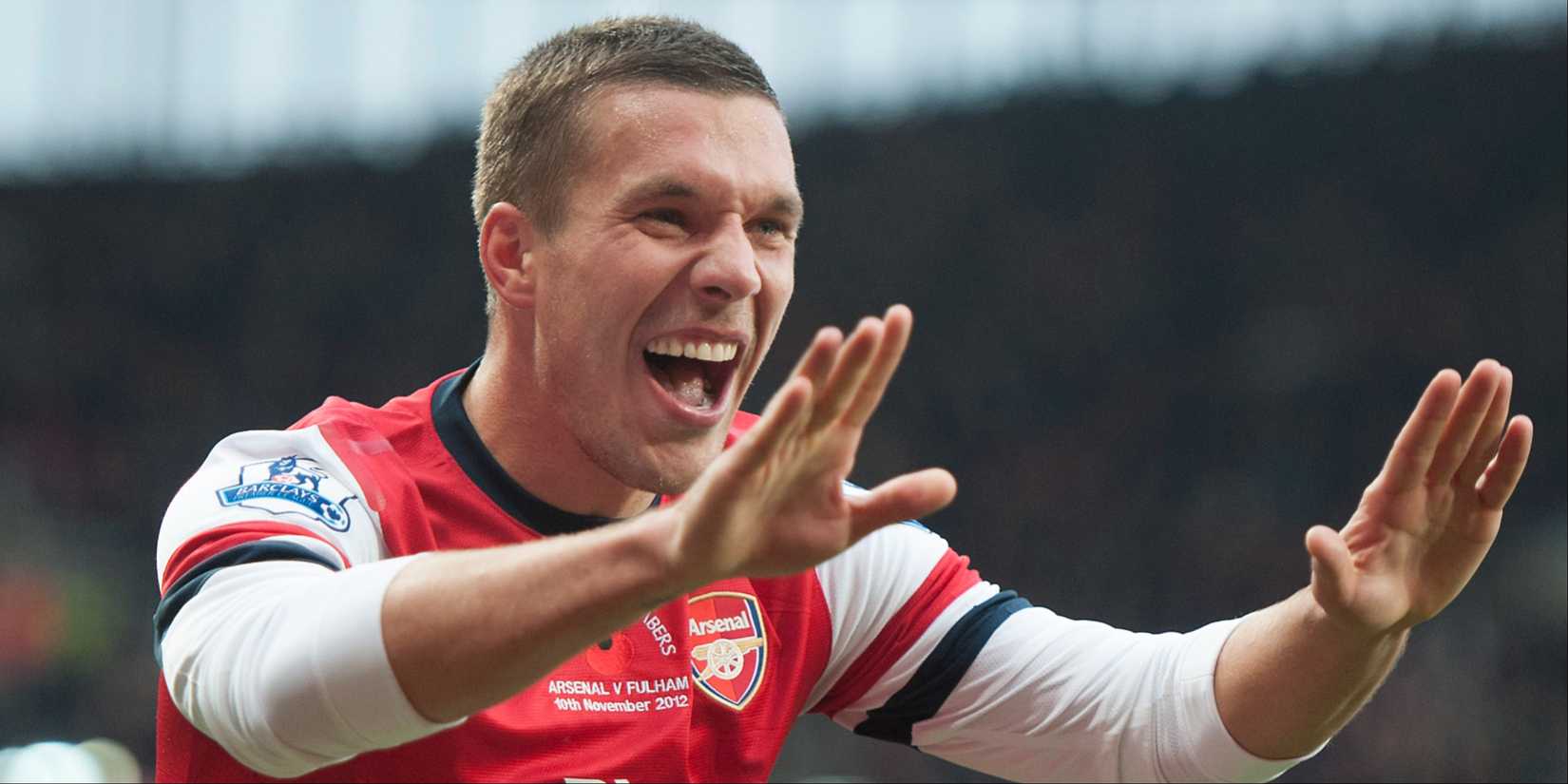 Lukas Podolski celebrates scoring for Arsenal against Fulham. 