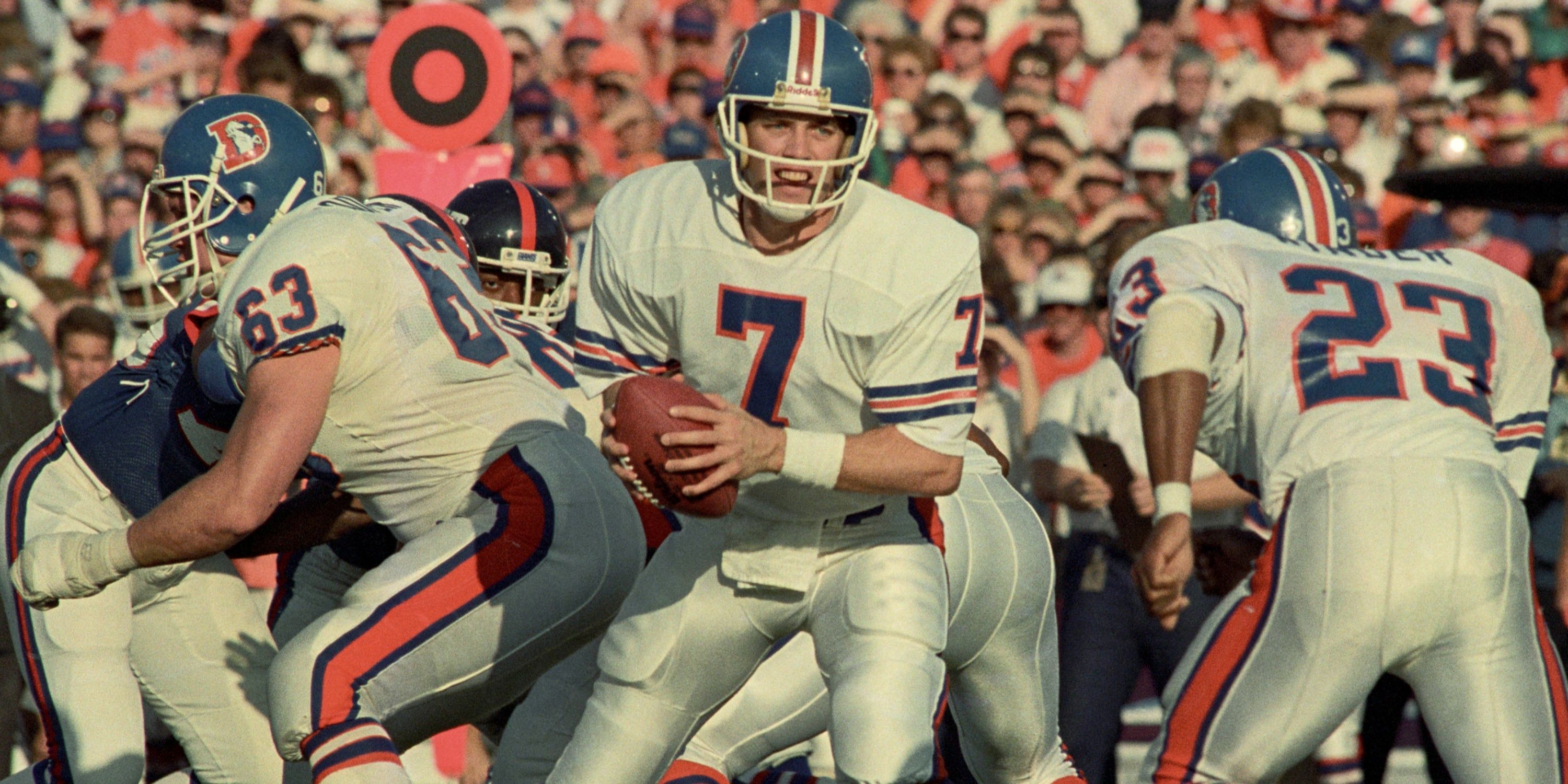 John Elway drops back during a 1980s NFL game