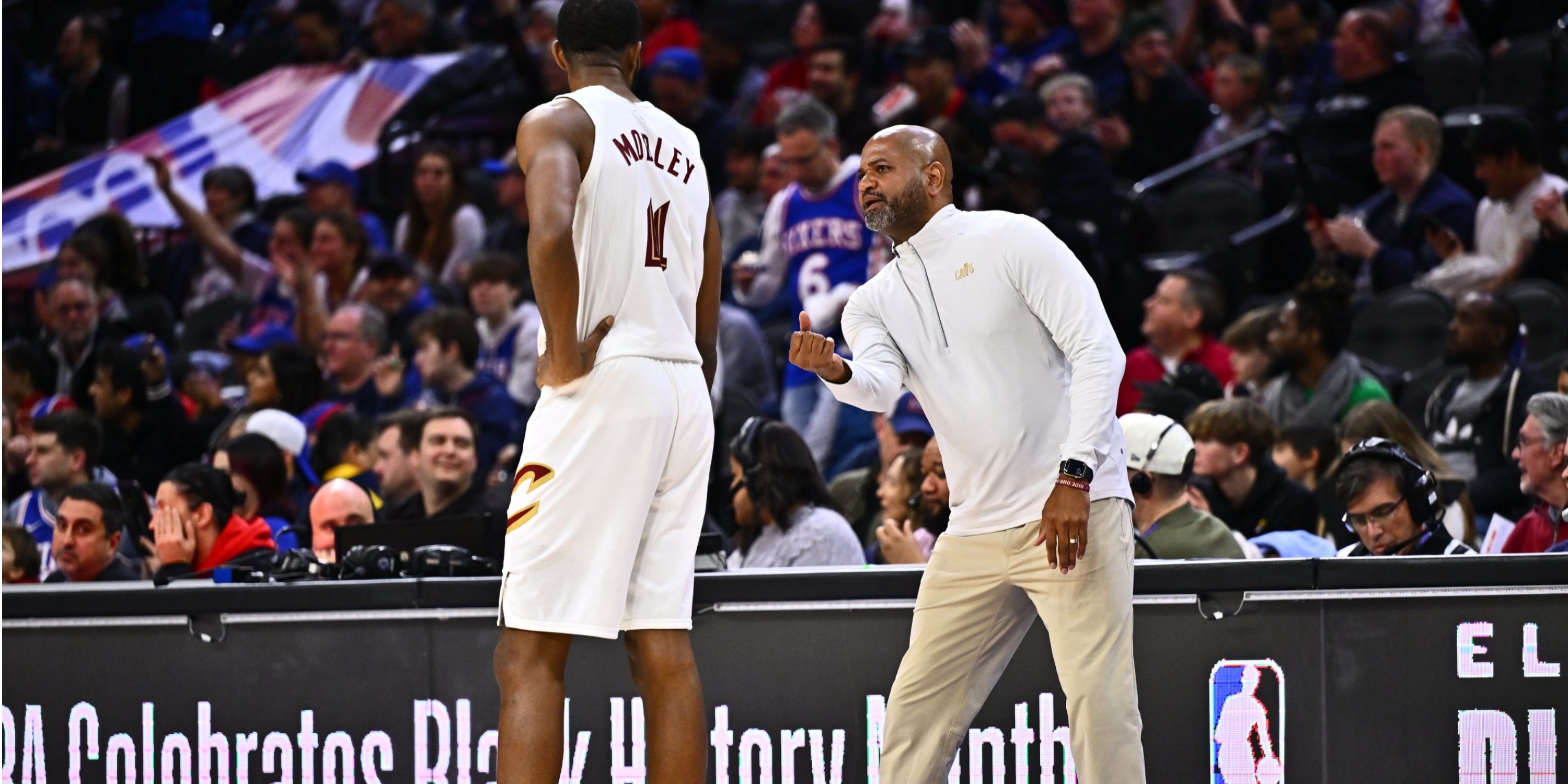 Cavs head coach JB Bickerstaff talks to forward Evan Mobley on the sideline