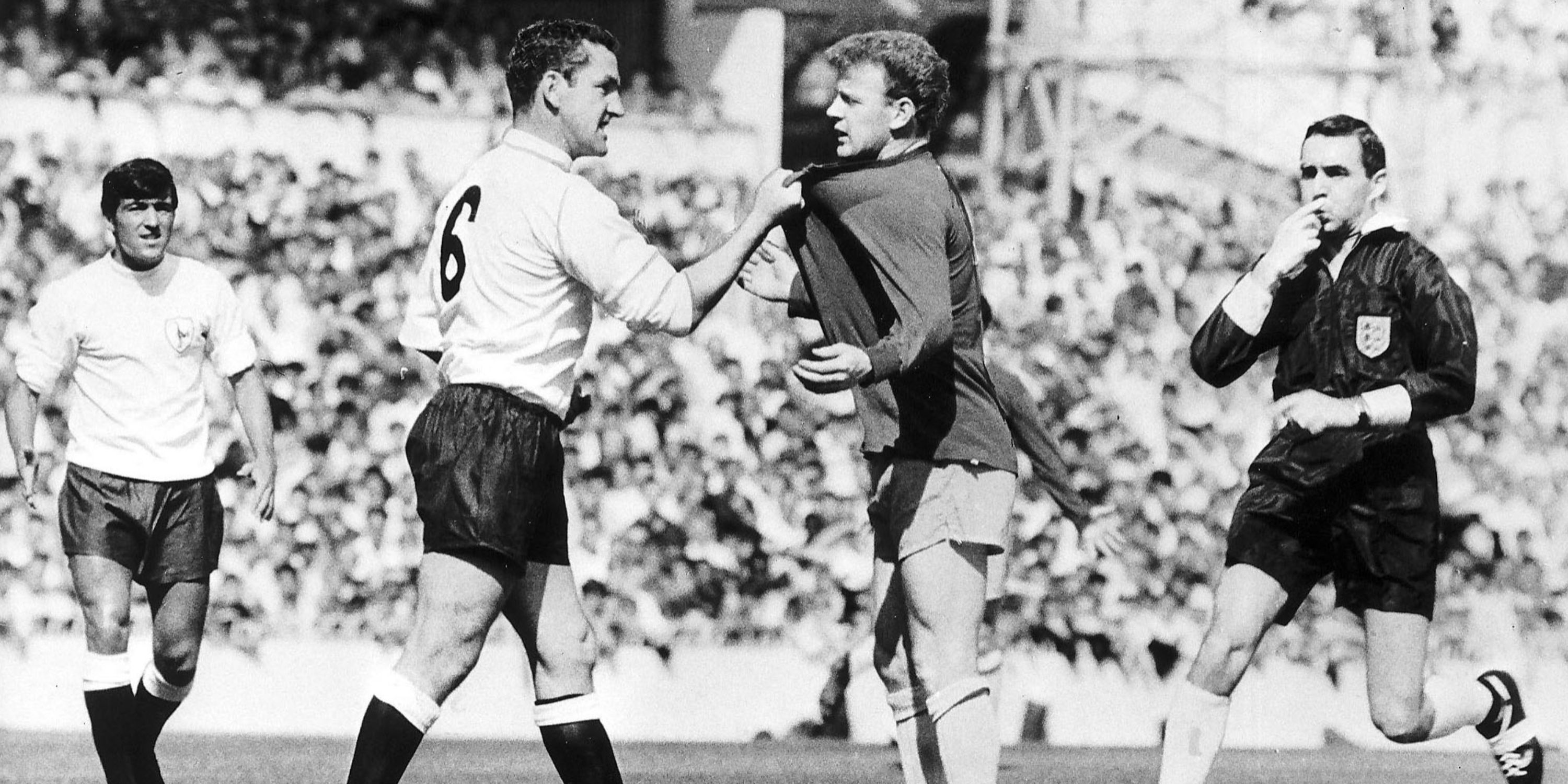 Dave Mackay (6) grabs a player's shirt