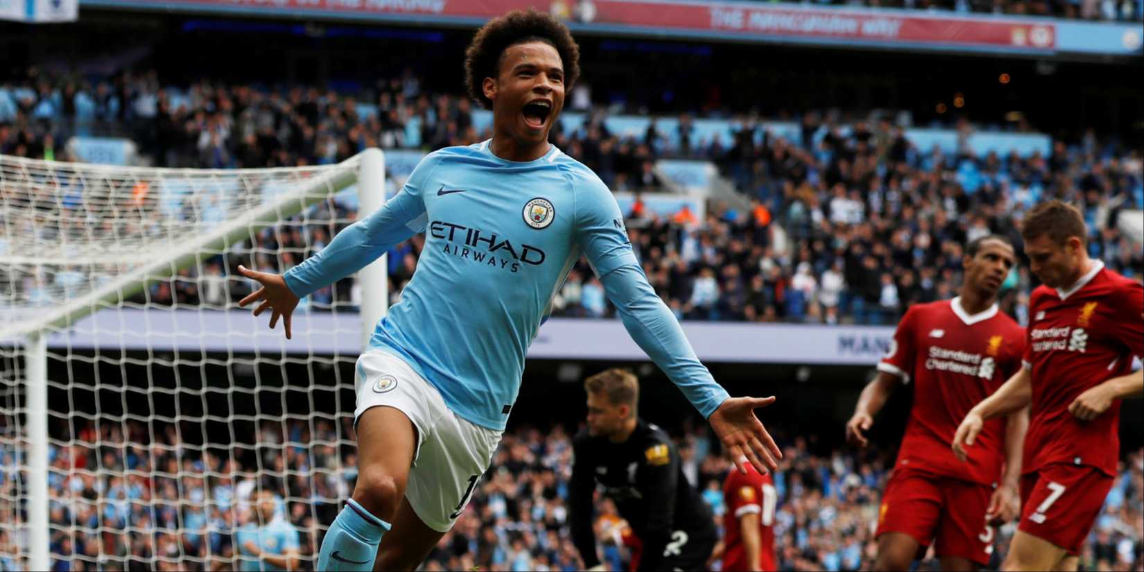 Manchester City's Leroy Sane celebrates scoring against a despondent Liverpool. 