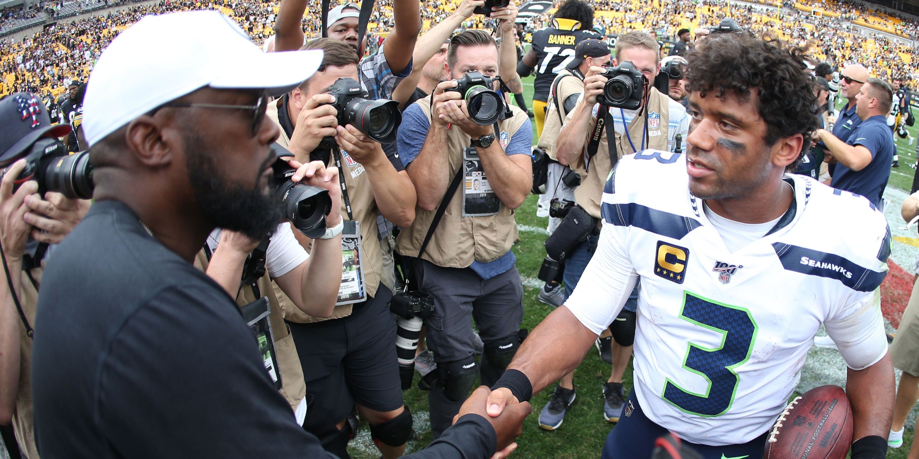 Mike Tomlin and Russell Wilson shake hands following an NFL game