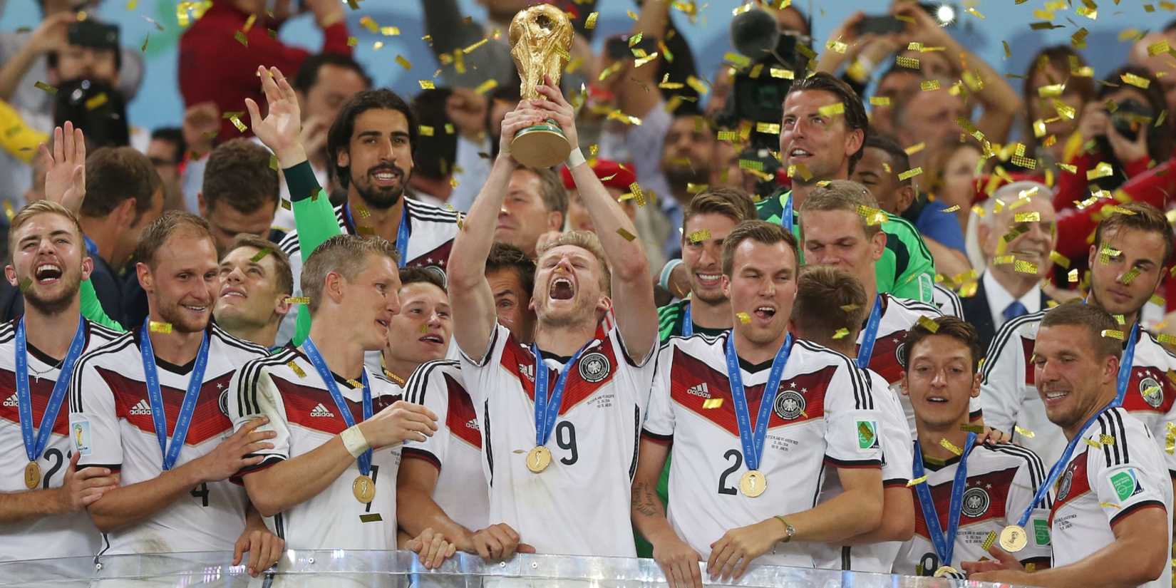 Germany's Andre Schurrle lifts the FIFA World Cup trophy