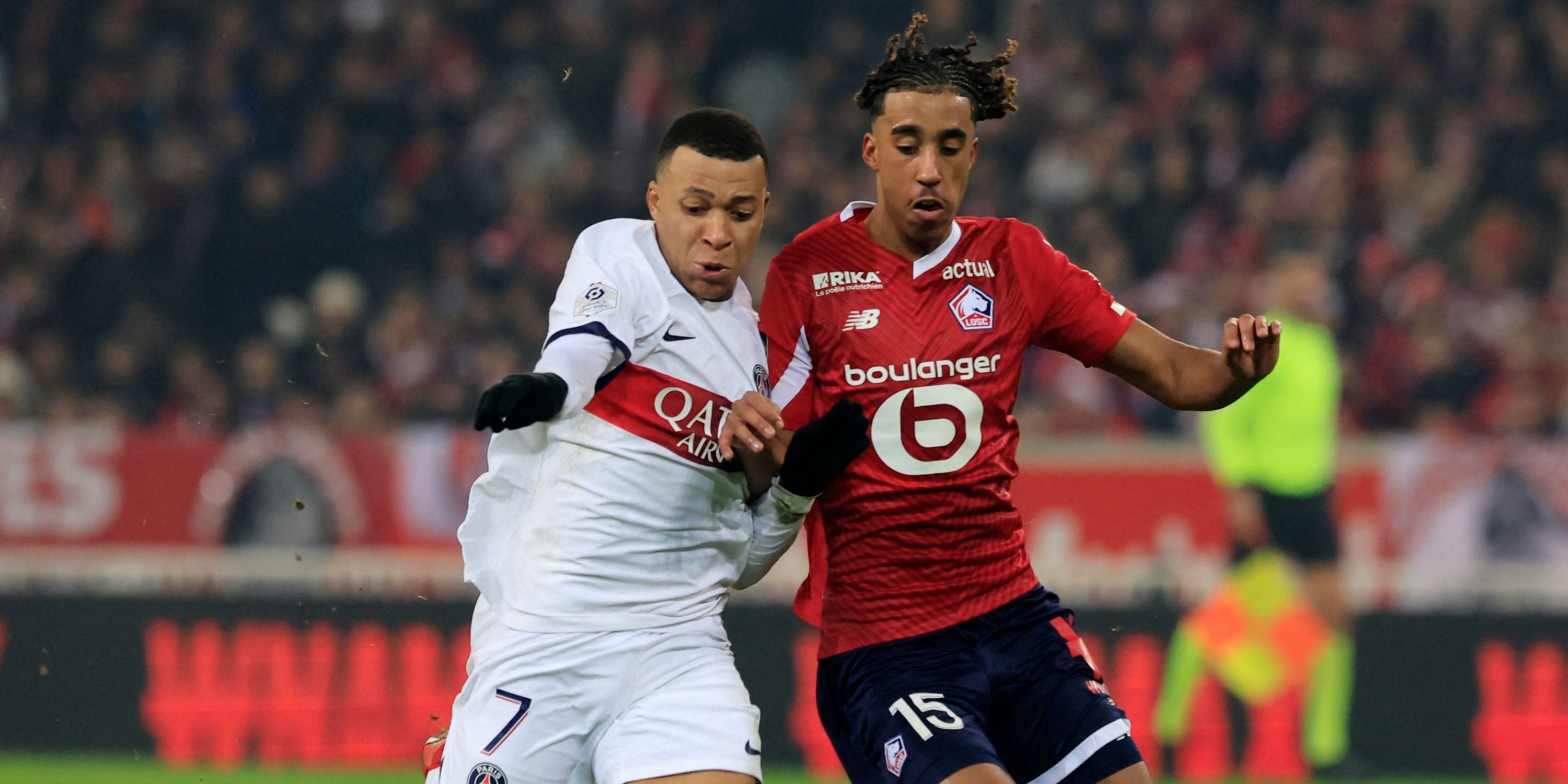 Paris Saint-Germain forward Kylian Mbappe in action with Lille centre-back Leny Yoro