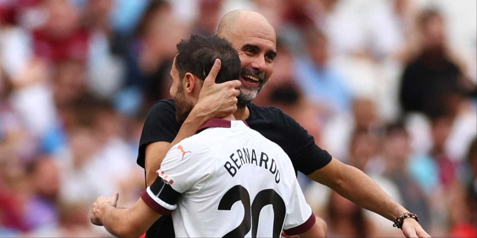 Manchester City manager Pep Guardiola embraces Bernardo Silva after a win.