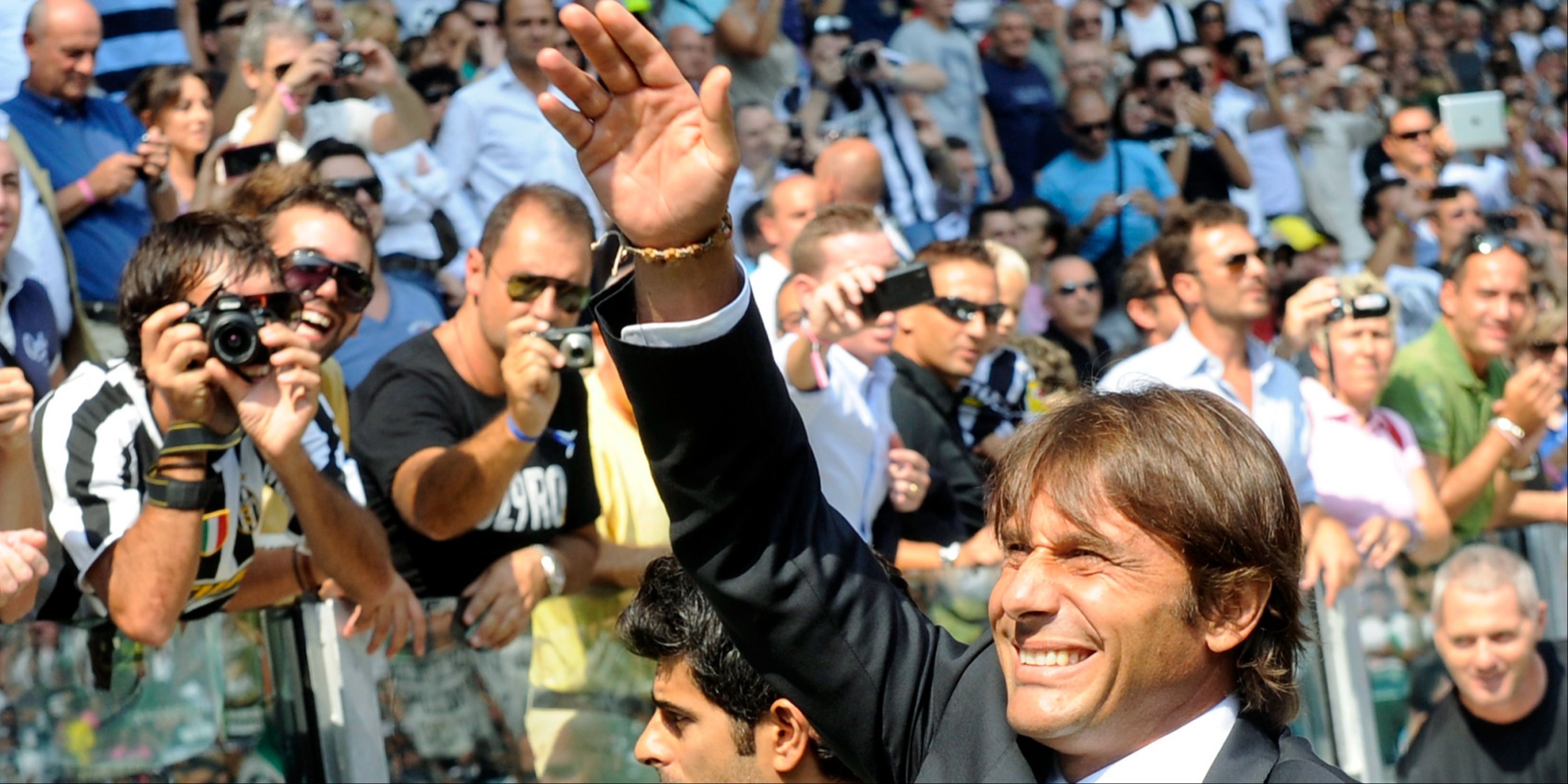 Juventus manager Antonio Conte greets the supporters. 
