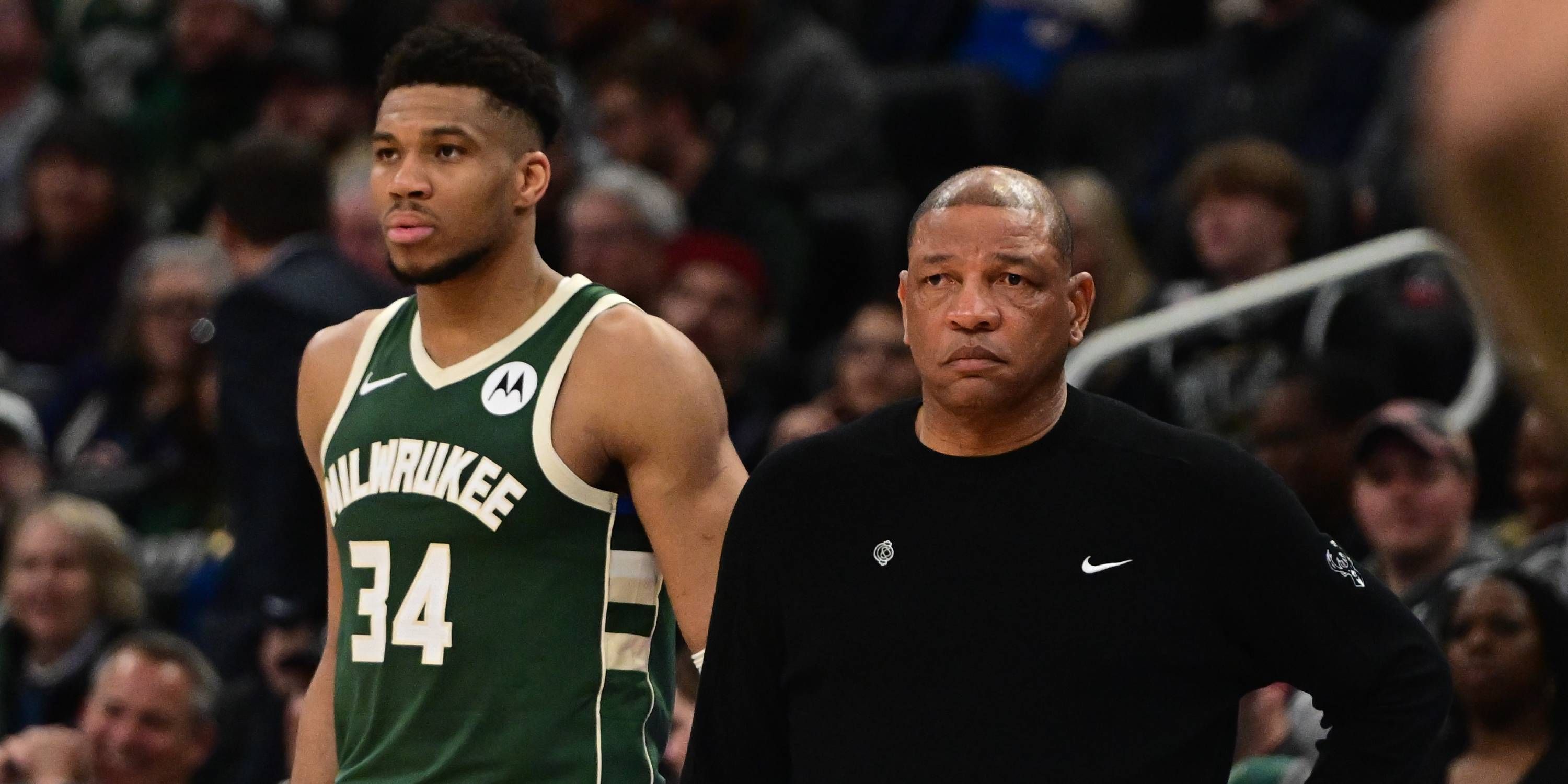 Doc Rivers and Giannis Antetokounmpo stand together courtside.
