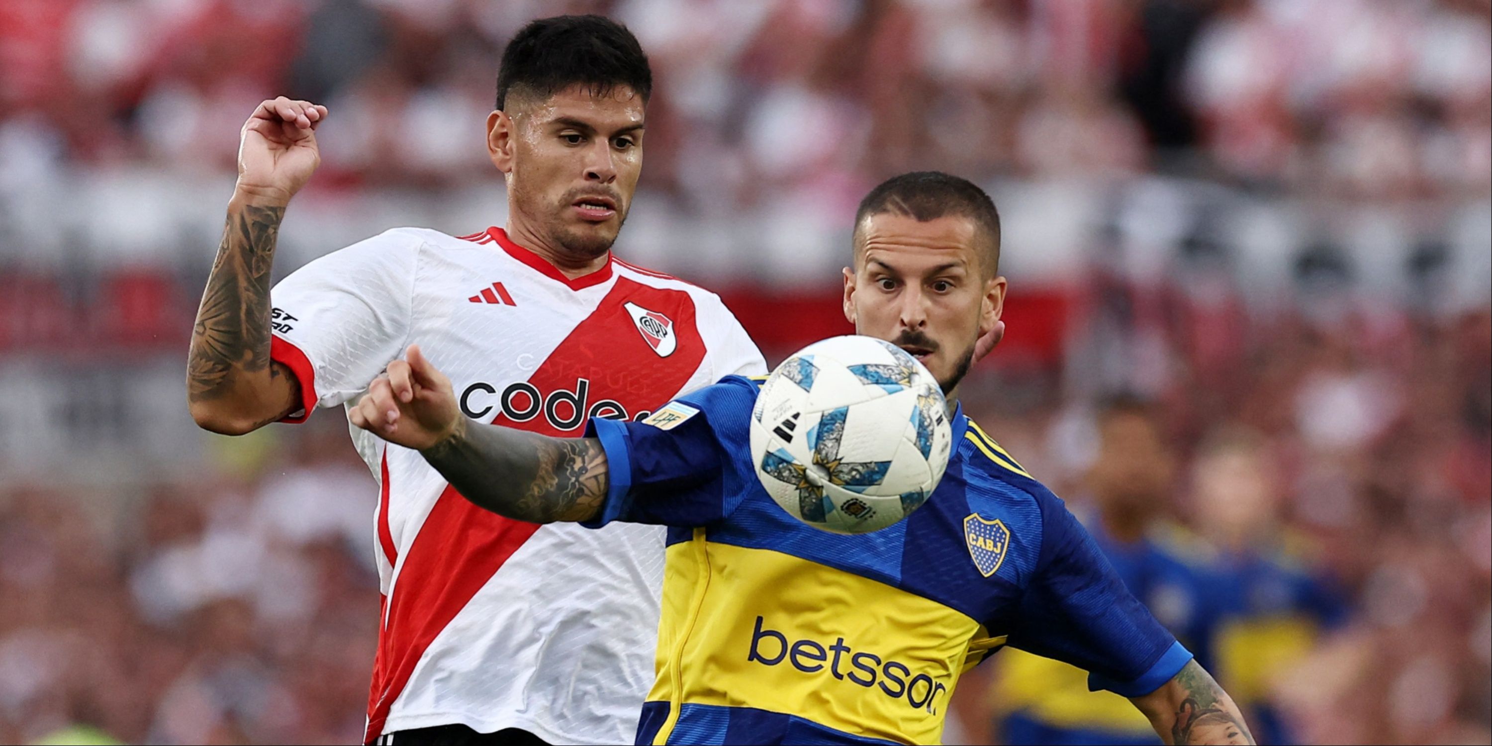 River Plate and Boca Juniors players battle for the ball