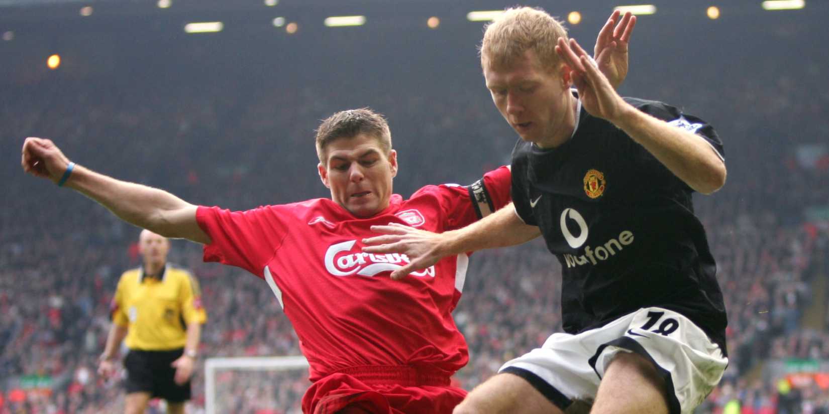 United's Paul Scholes is challenged by Liverpool's Steven Gerrard