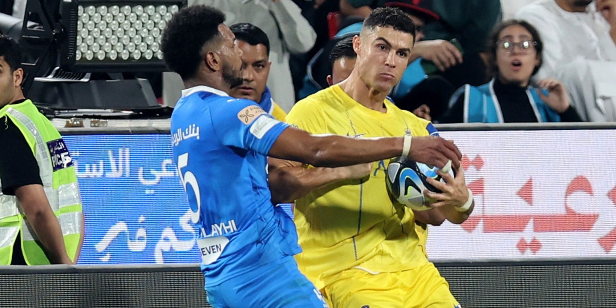 Al Nassr's Cristiano Ronaldo clashes with Al Hilal's Ali Al Bulayhi before being shown a red card by referee Mohammed Al Hoaish