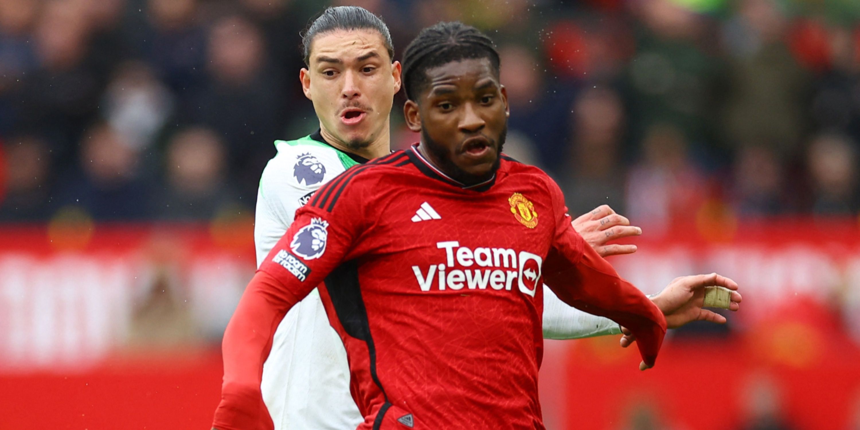 Liverpool striker Darwin Nunez and Manchester United defender Willy Kambwala battling for possession