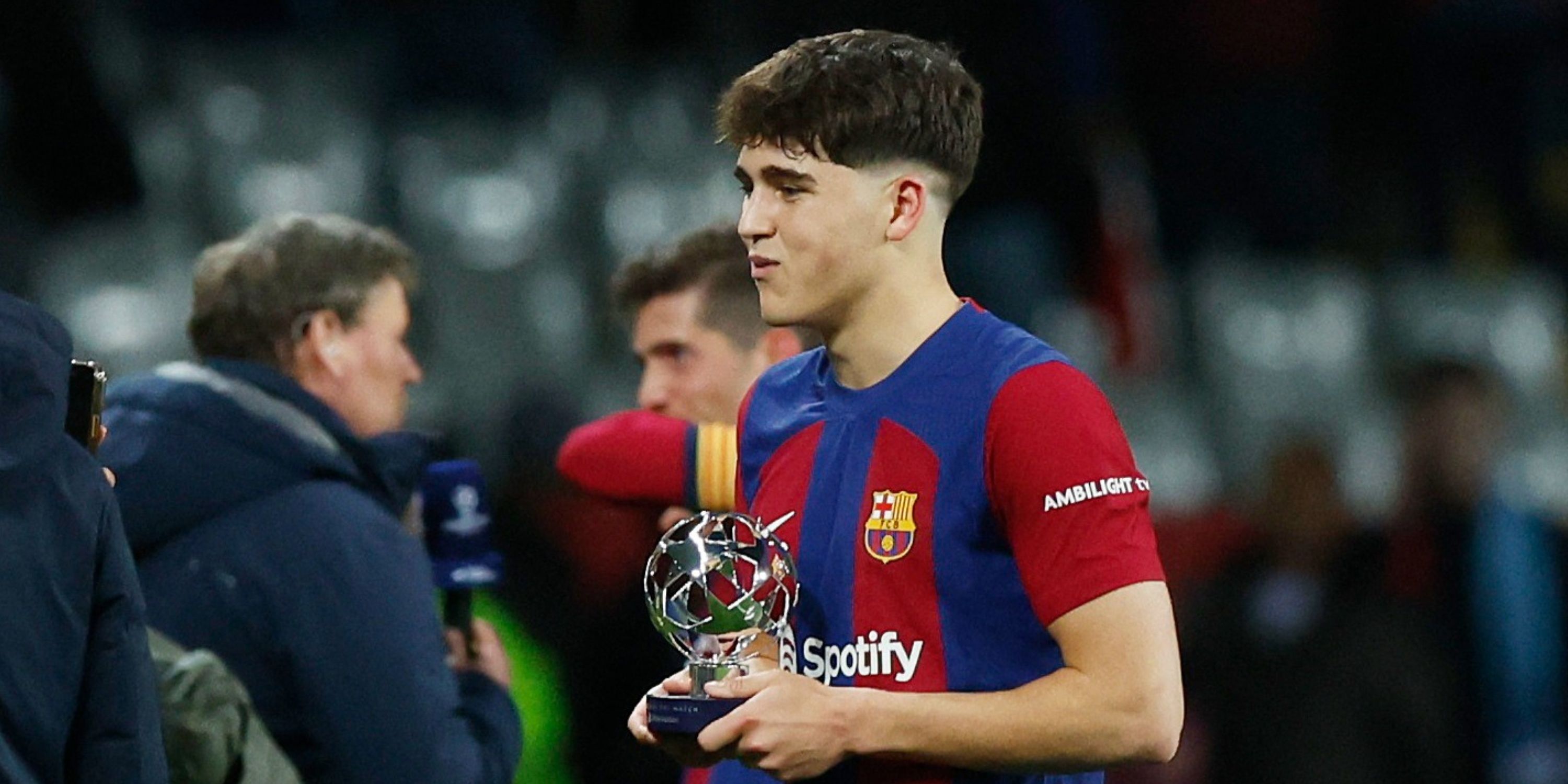 Pau Cubarsi holding a trophy for Barcelona