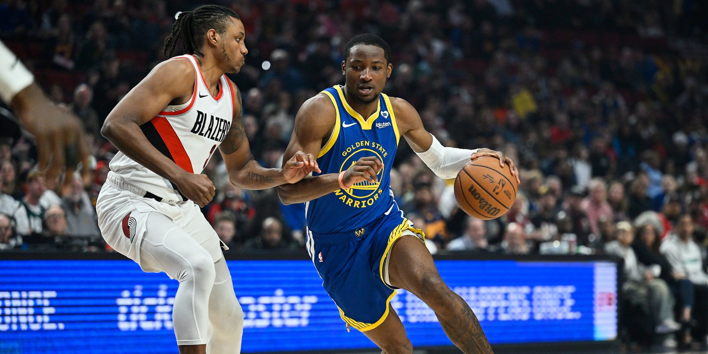 Warriors forward Jonathan Kuminga drives against Blazers forward Jabari Walker