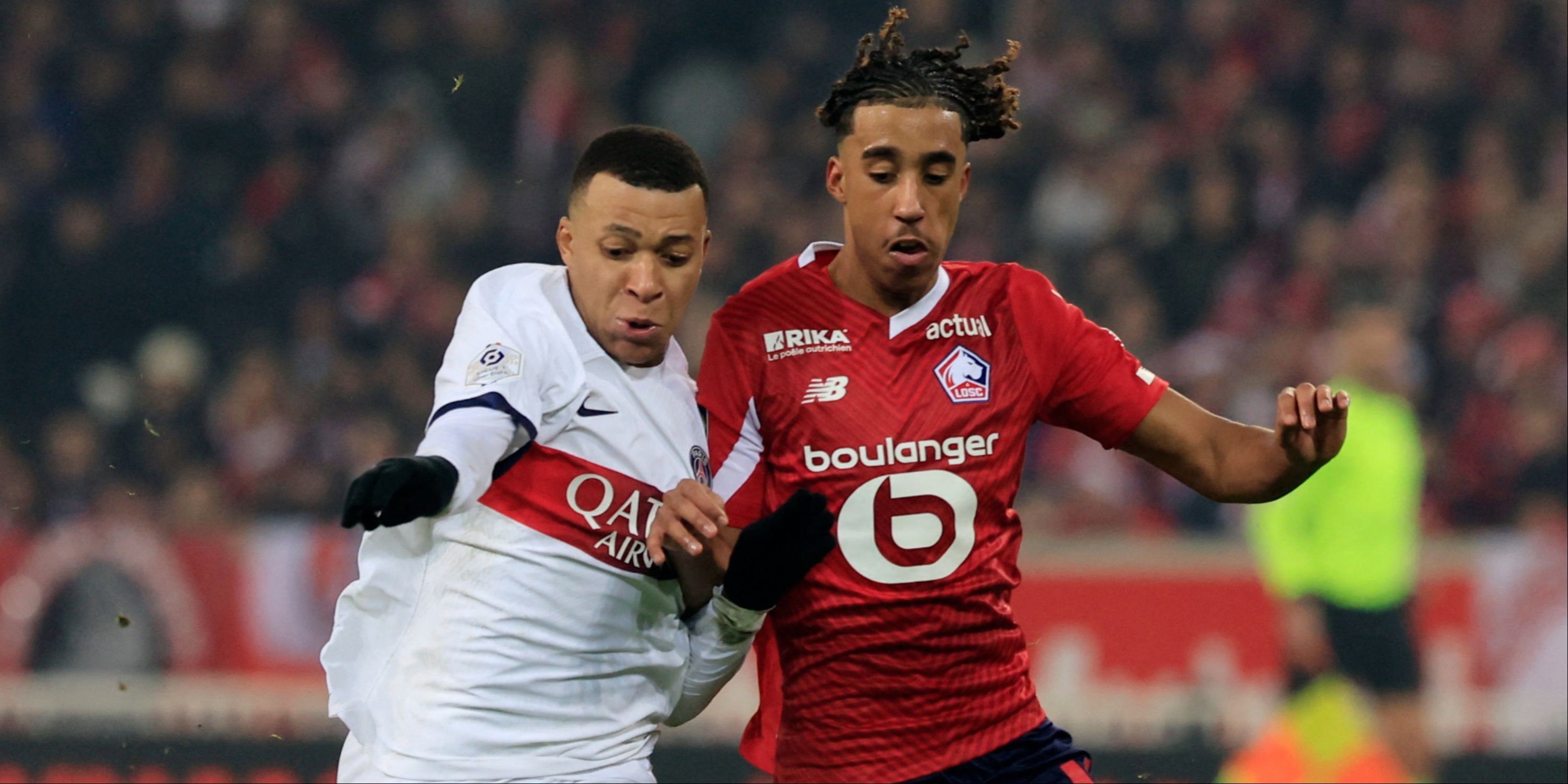 Lille defender Leny Yoro and Paris Saint-Germain attacker Kylian Mbappe battle for the ball