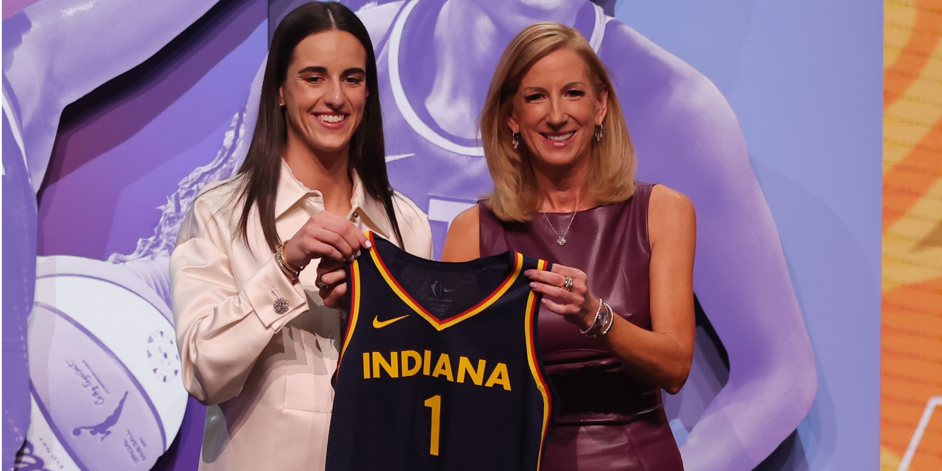 Caitlin Clark poses with WNBA Commissioner Cathy Englebert after being selected with the first pick in the 2024 WNBA Draft.