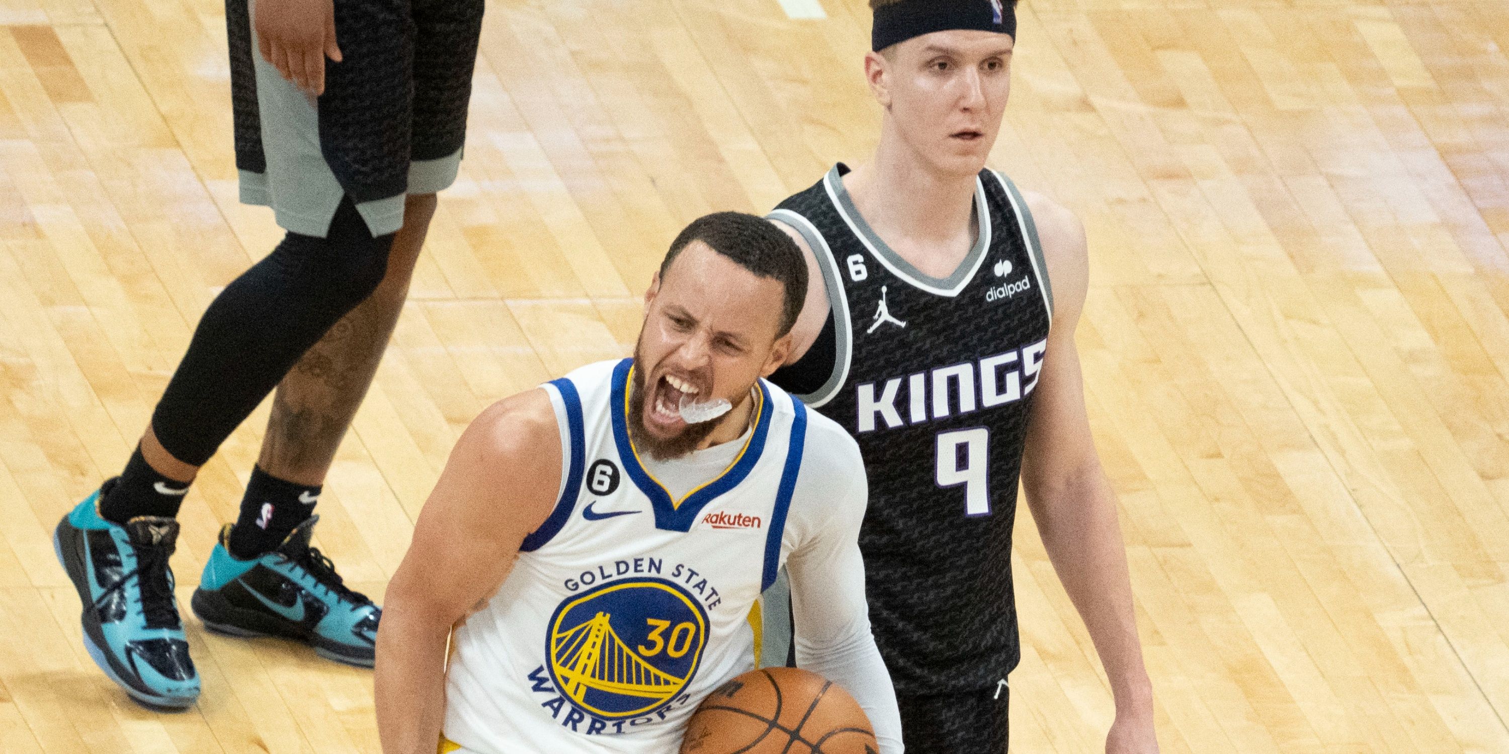 Stephen Curry celebrating with Kevin Huerter behind