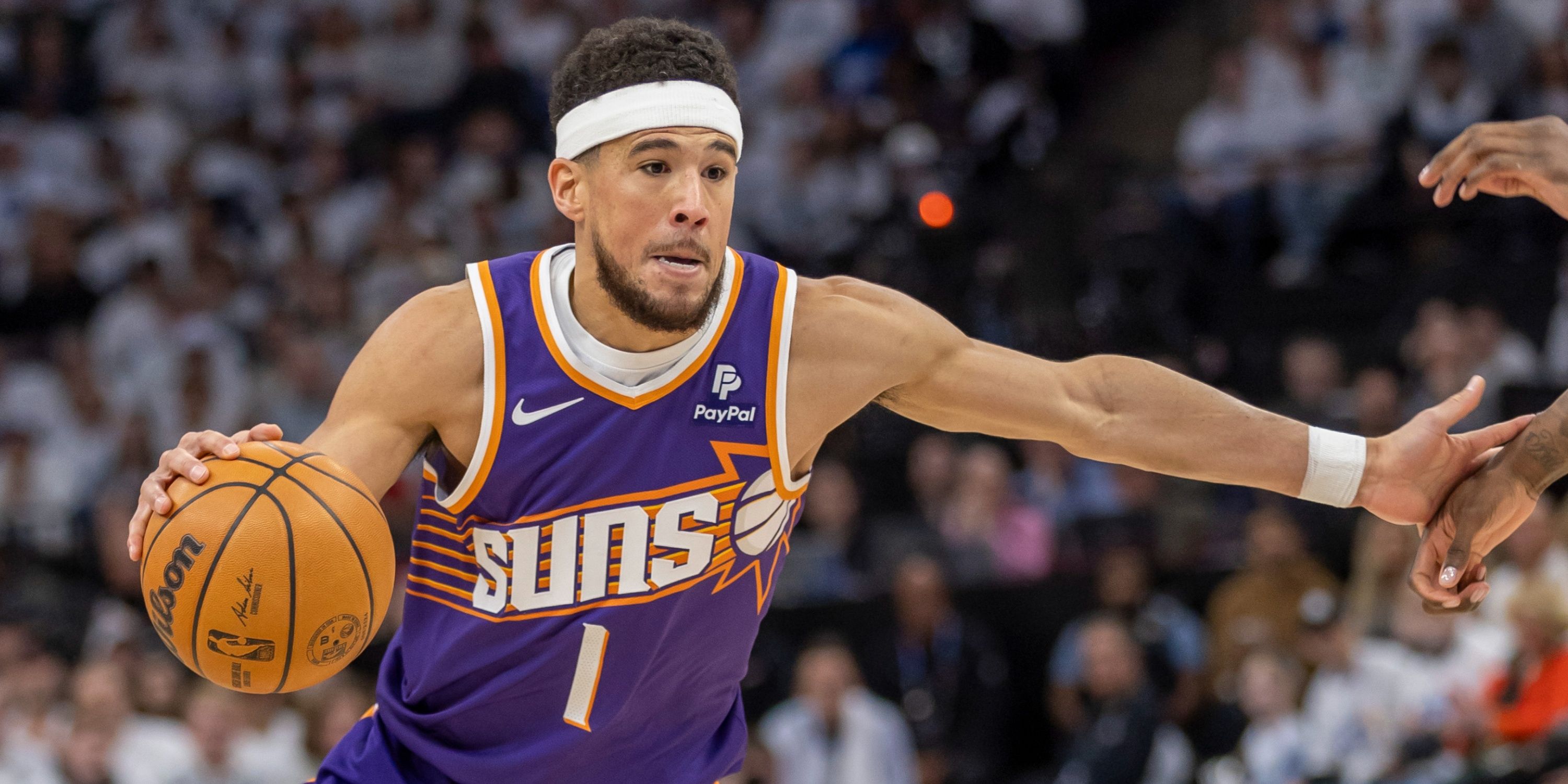 Phoenix Suns guard Devin Booker dribbles the ball during Game 1 of the Suns' first round series against the Minnesota Timberwolves in the 2024 NBA Playoffs.